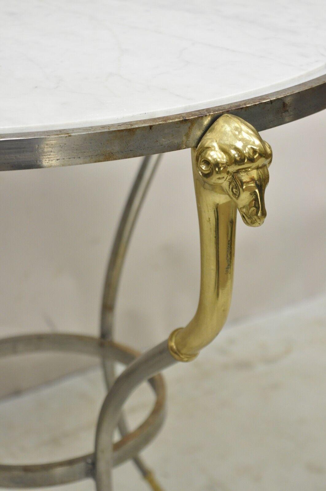Italian Neoclassical Style Brass Rams Head Steel Metal Round Marble Side Table.. Item features a steel metal frame, brass accents, white round marble top. Circa Late 20th Century. Measurements: 26