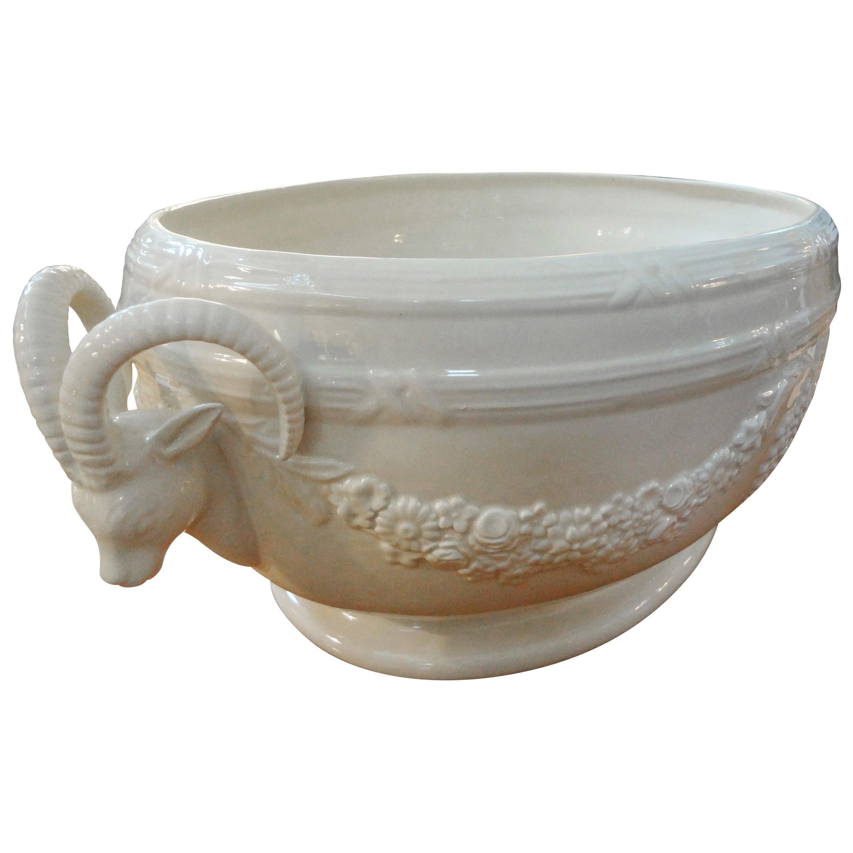 Stunning Italian
Neoclassical style white creamware or glazed pottery planter, jardinière or cachepot. This lovely Italian jardinière has ram's heads on either side and is deep enough to accommodate two 6