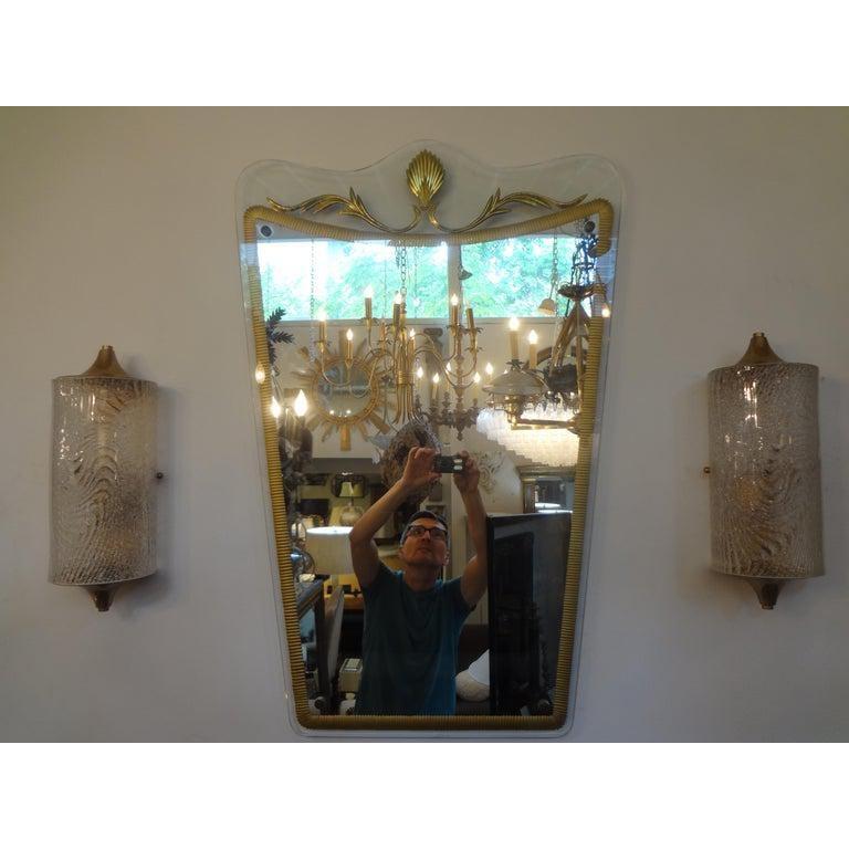 Italian neoclassical style Fontana Arte inspired mirror.
Outstanding Italian neoclassical style mirror in the style of Pietro Cheisa for Fontana Arte. This fabulous Italian midcentury transparent mirror has an unusual gilt decorated design. This