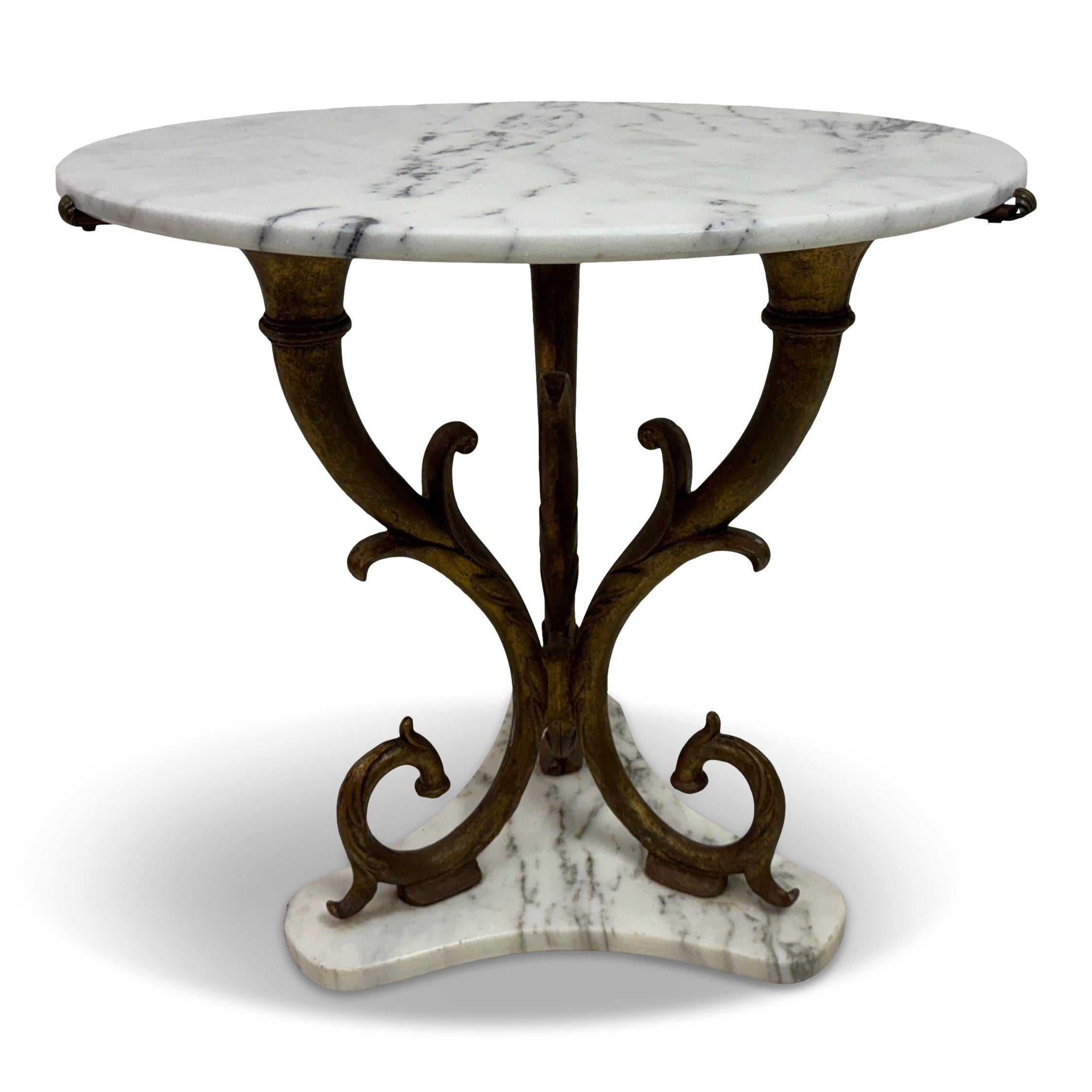 Italian Neoclassical-Style Gilt Iron and Marble Side Table, 1950s

A graceful and sculptural Italian side table from the 1950s, combining classical inspiration with mid-century elegance. The circular white marble top rests on an ornate gilt iron