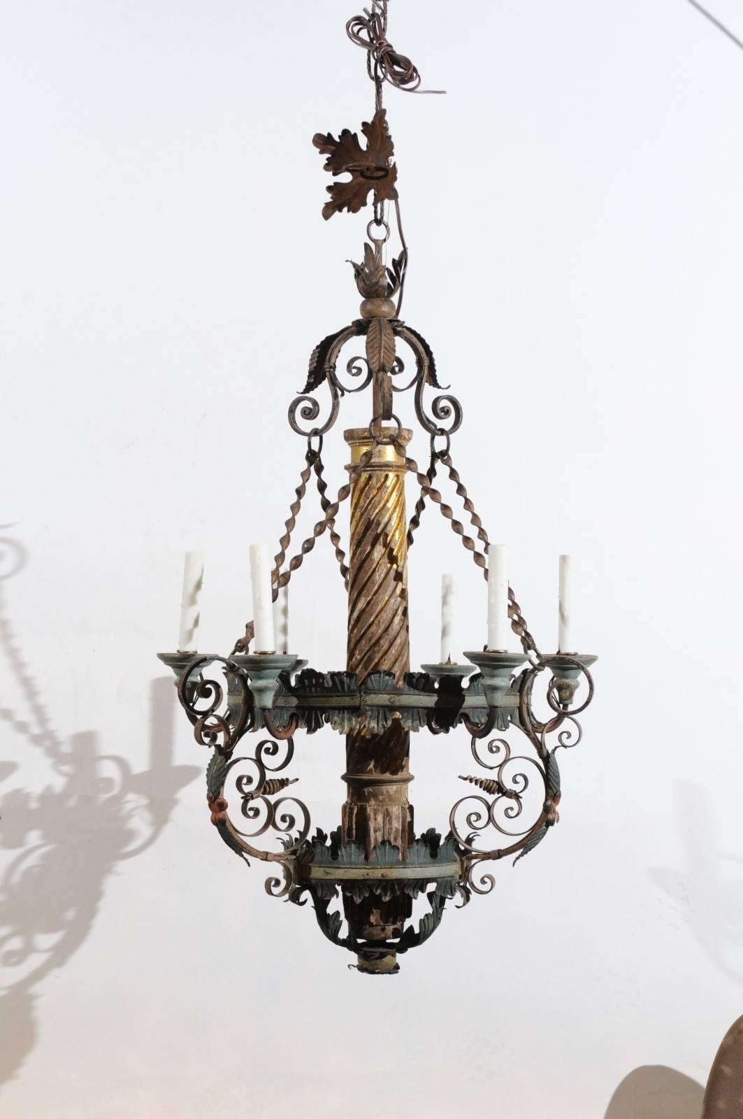 The Italian neoclassical style chandelier with twisted giltwood center column with green painted tole, scroll iron detail and six lights. Constructed out of 19th century elements. 



 