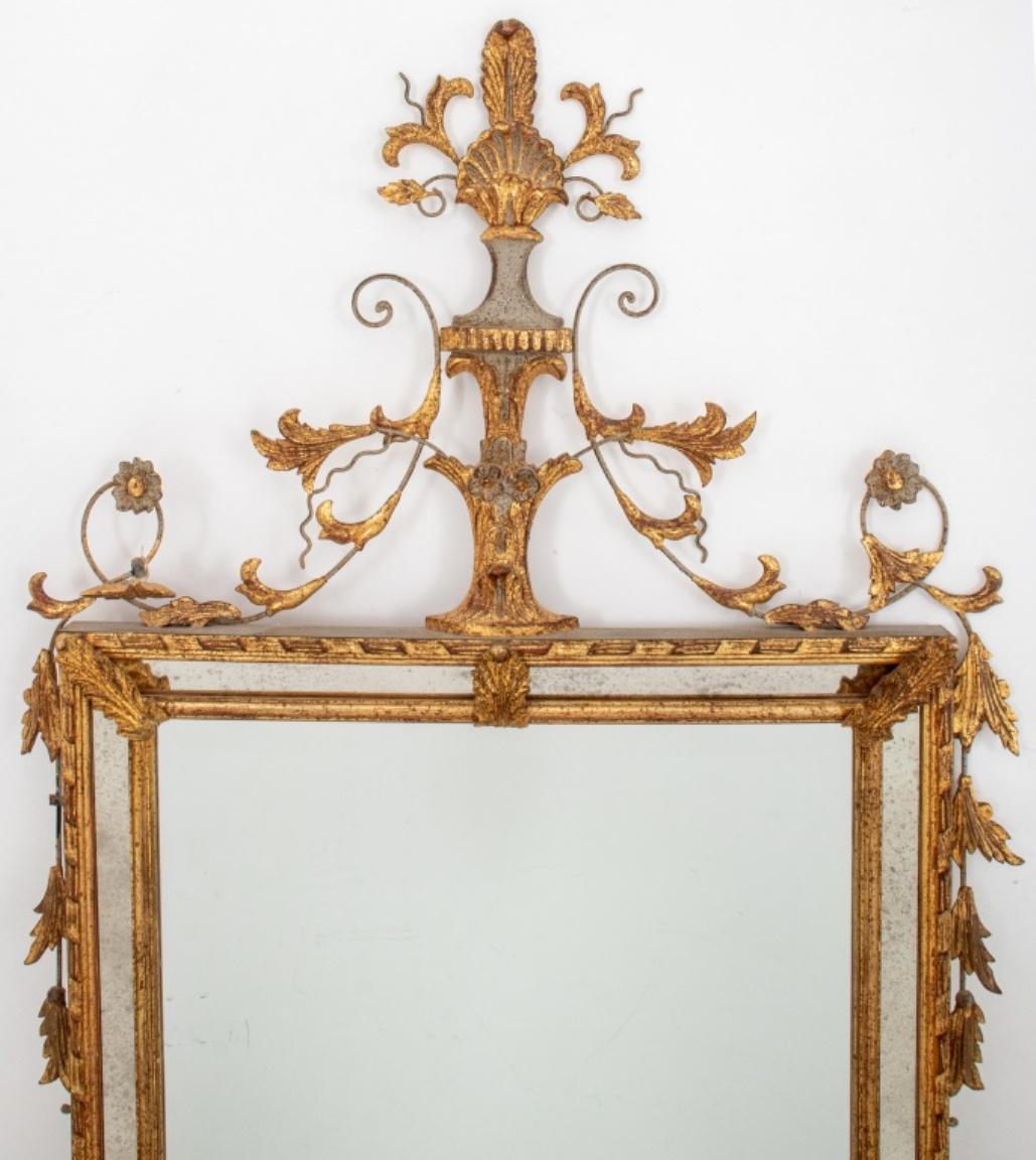Italian Neoclassical style giltwood mirror, of typical form with giltwood scrollwork cornice above a rectangular architectural giltwood border with leaf-bound mirror segments centering a rectangular beveled mirror plate.

Dimensions: Mirror:  32