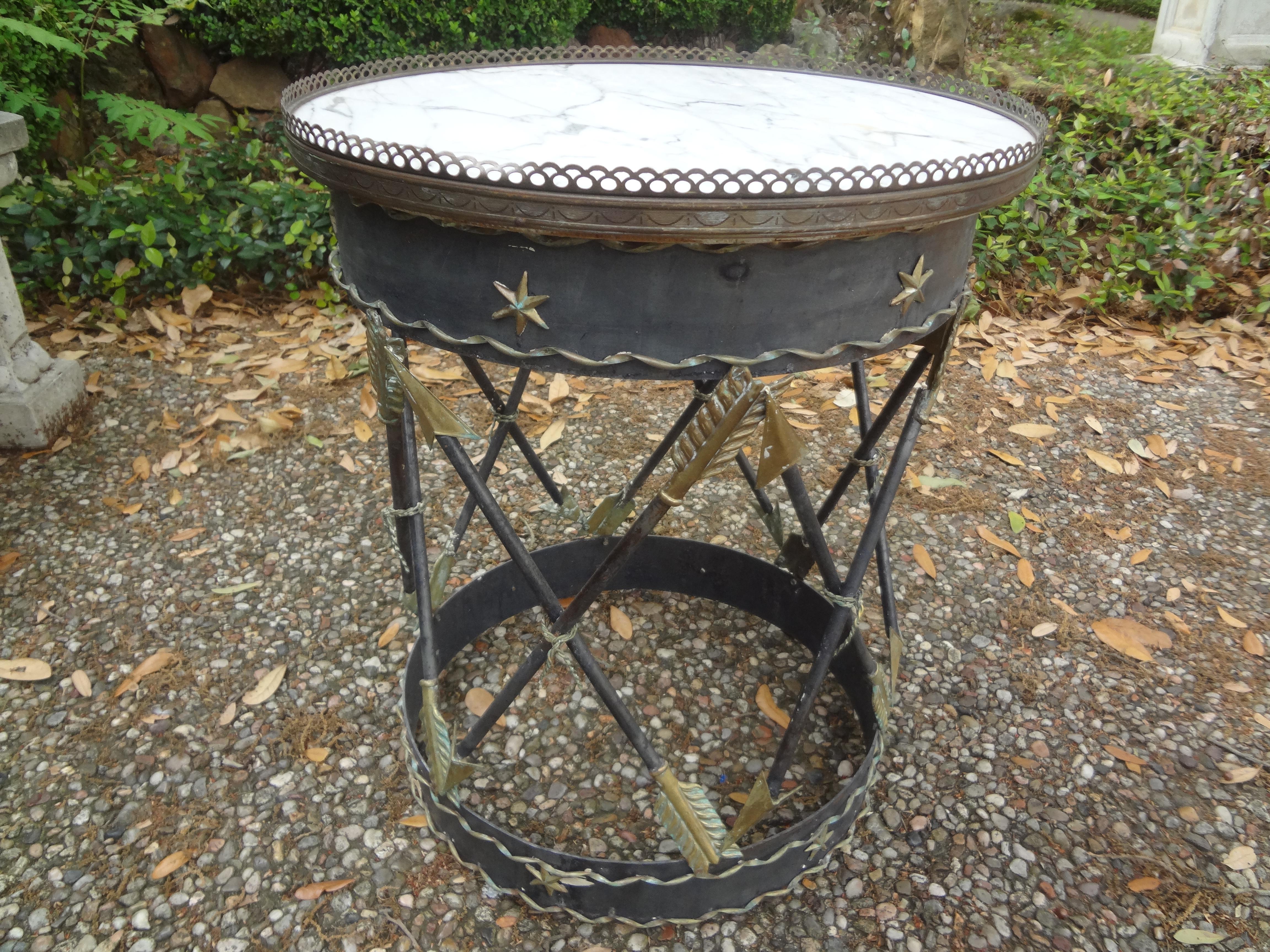 Italian Neoclassical style iron and tole table with arrows.
Stunning vintage Italian neoclassical style iron and tole drum table with arrows, stars and a marble top. This versatile side table, drink table, or gueridon is perfect between two chairs
