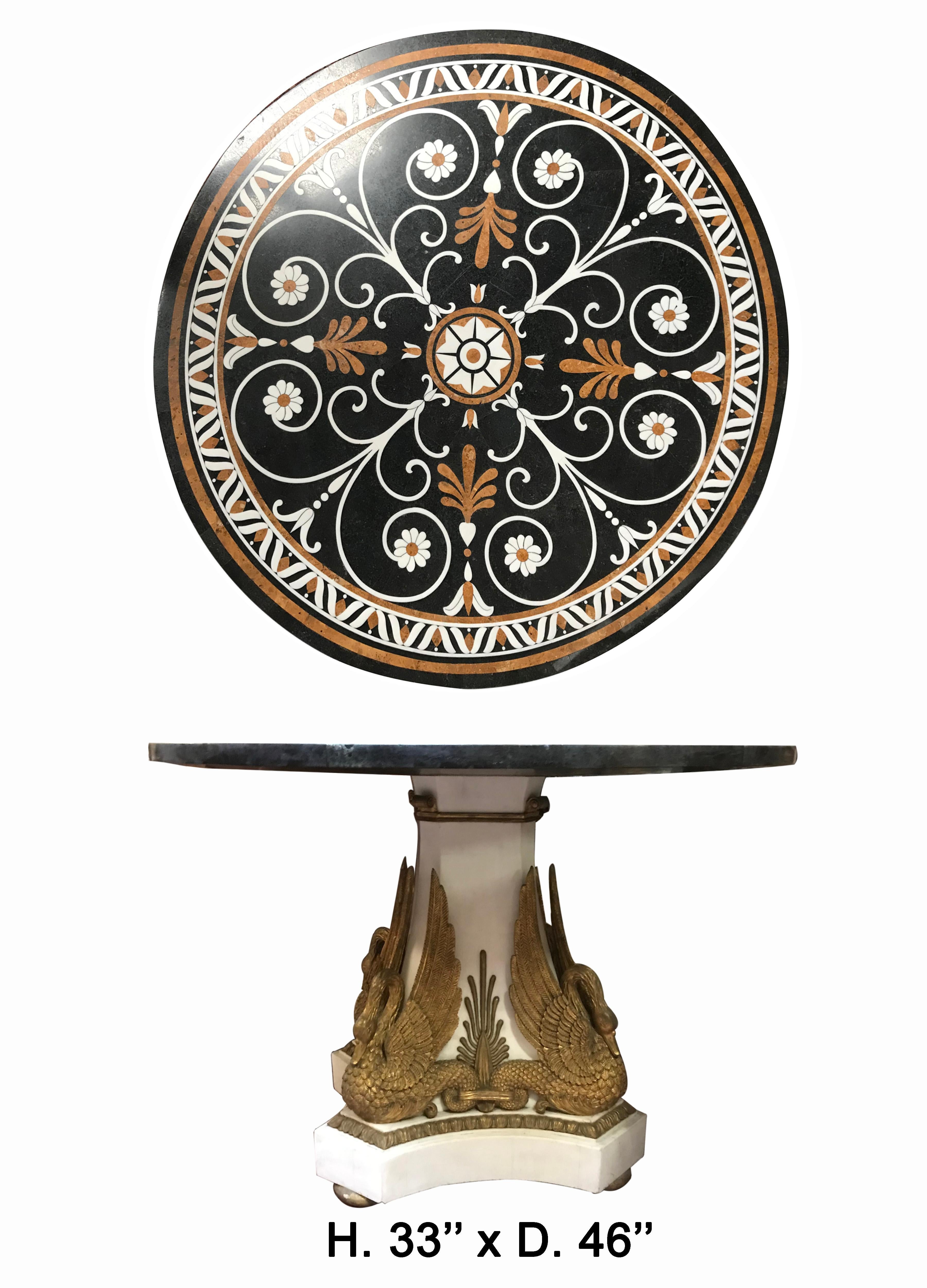 Italian neoclassical style marble round center table.

The round top is beautifully veneered with pretty various marble in a floral and foliate motif, over a white veneered marble tripod base with four fine gilt resin swans, raised on a conforming