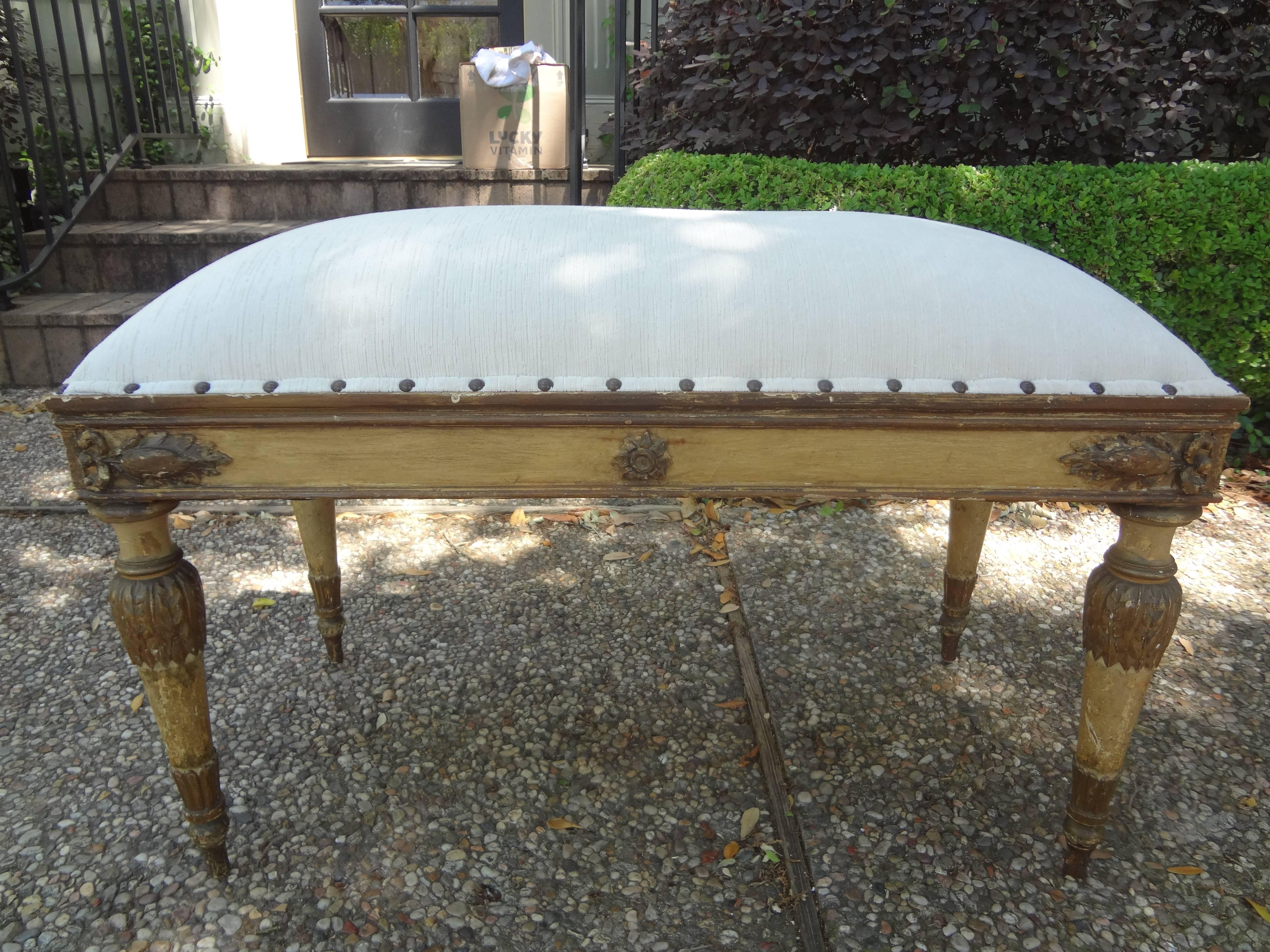 Stunning Italian Neoclassical style painted and gilt bench. This Italian 1920s Directoire style bench was taken down to the frame and professionally upholstered with cream striated cut velvet and spaced brass nail head detail. Our versatile Italian