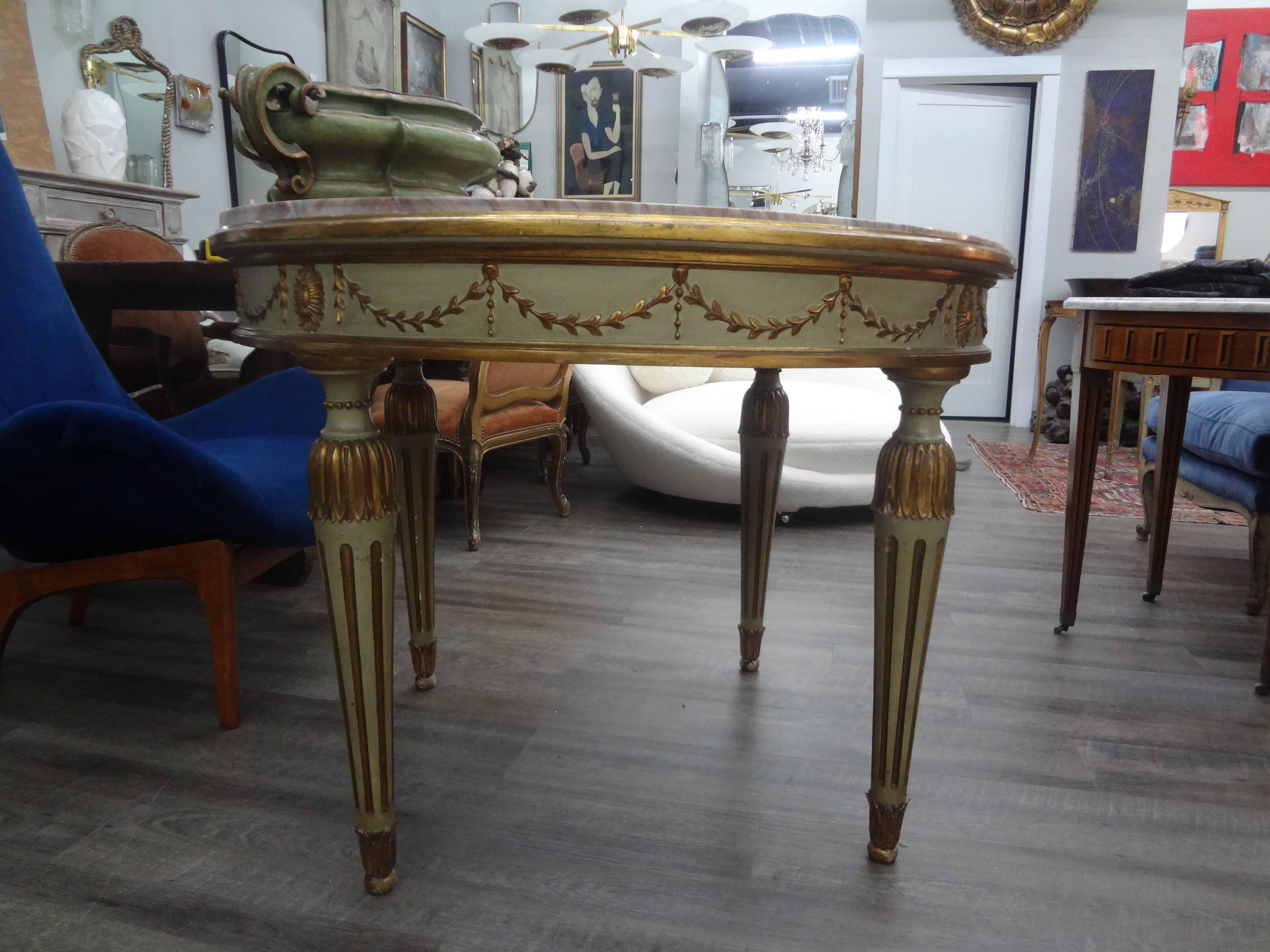 Italian Neoclassical Style Painted and Parcel Gilt Center Table.
This versatile antique Italian painted and parcel giltwood table can be used as a center table, dining table or game table. It retains the beautiful original marble top.
Stunning!
