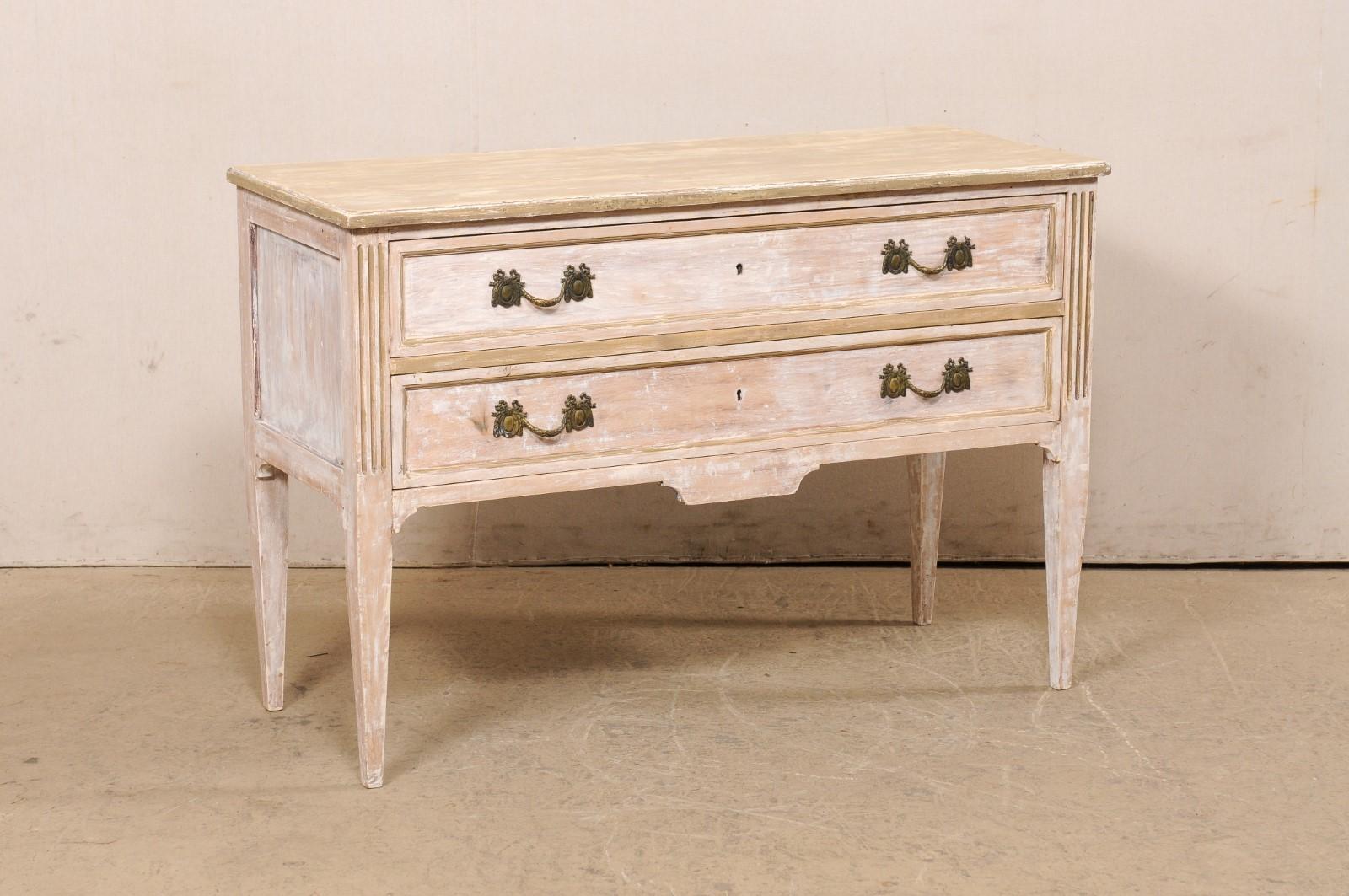 An Italian Neoclassic style raised two-drawer chest of drawers from the mid 20th century. This vintage chest from Italy features a rectangular-shaped top, which slightly overhangs the case below, which houses two drawers fitted with lovely