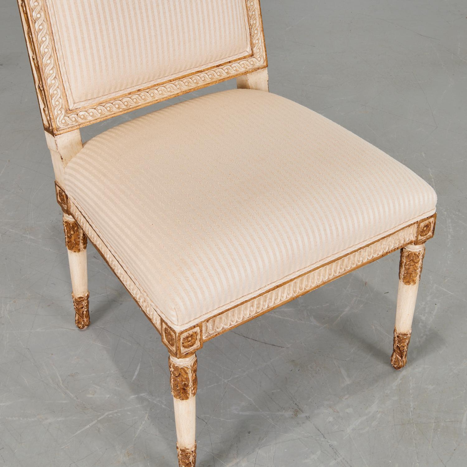 20th Italian neoclassical style slipper chair with a cream and gold painted carved frame, a cream striped upholstered seat and back.  Unmarked.

Dimensions:
37.75