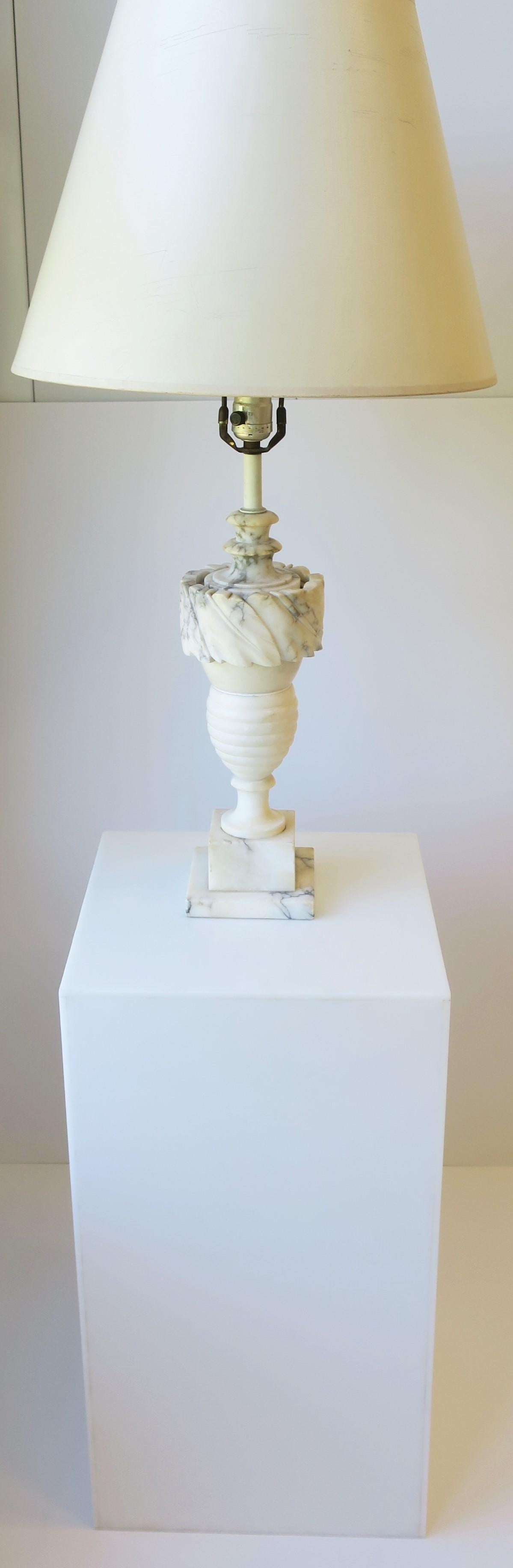 A beautiful and substantial Italian Neoclassical revival style urn form carved solid marble table or desk lamp, circa mid-20th century, Italy. Lamp is made of white marble and Carrara marble with black and gray veining. In fine working order.