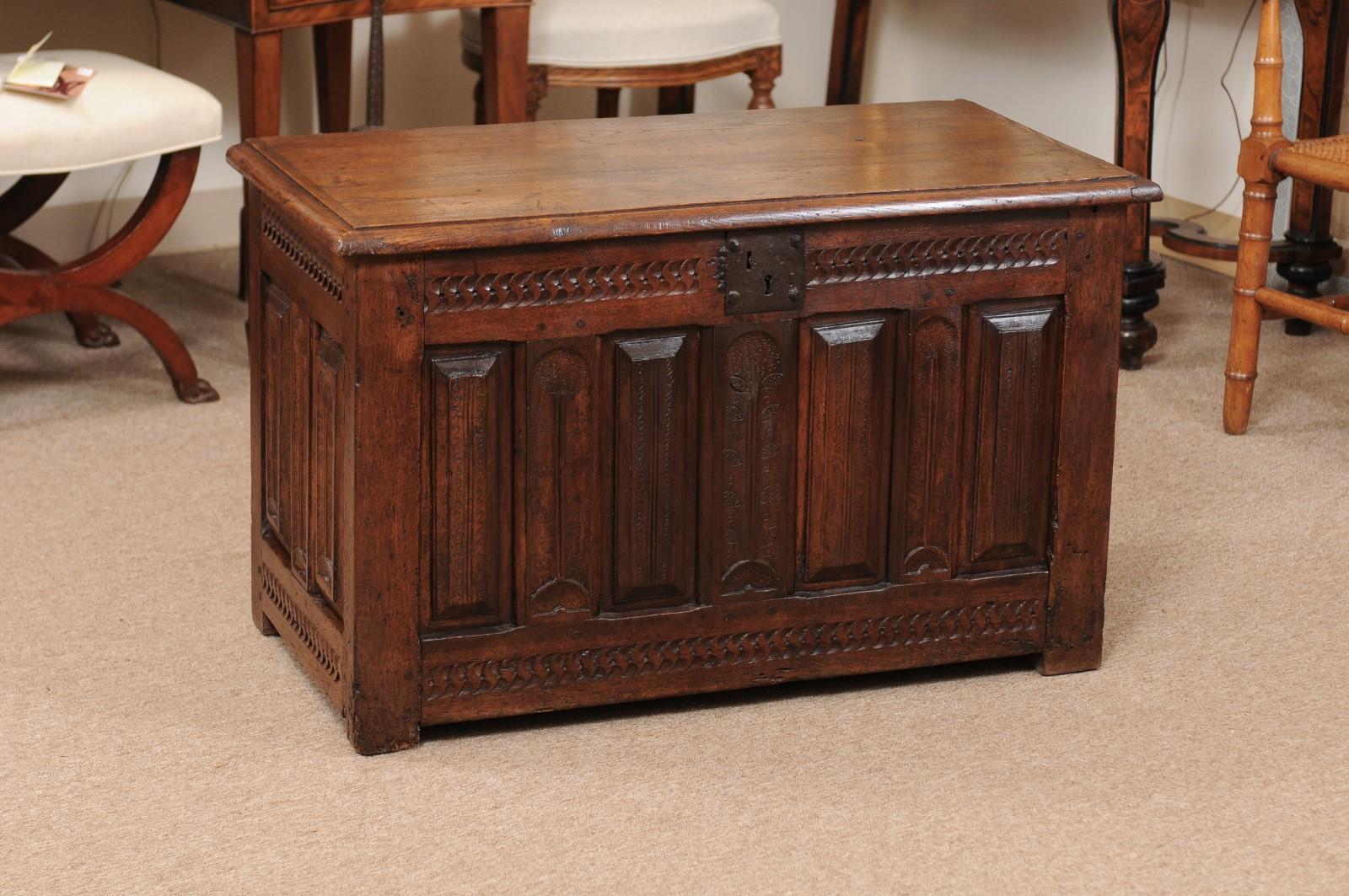 An Italian late 17th century oak cassone with carved front and sides in a foliage and geometric design.