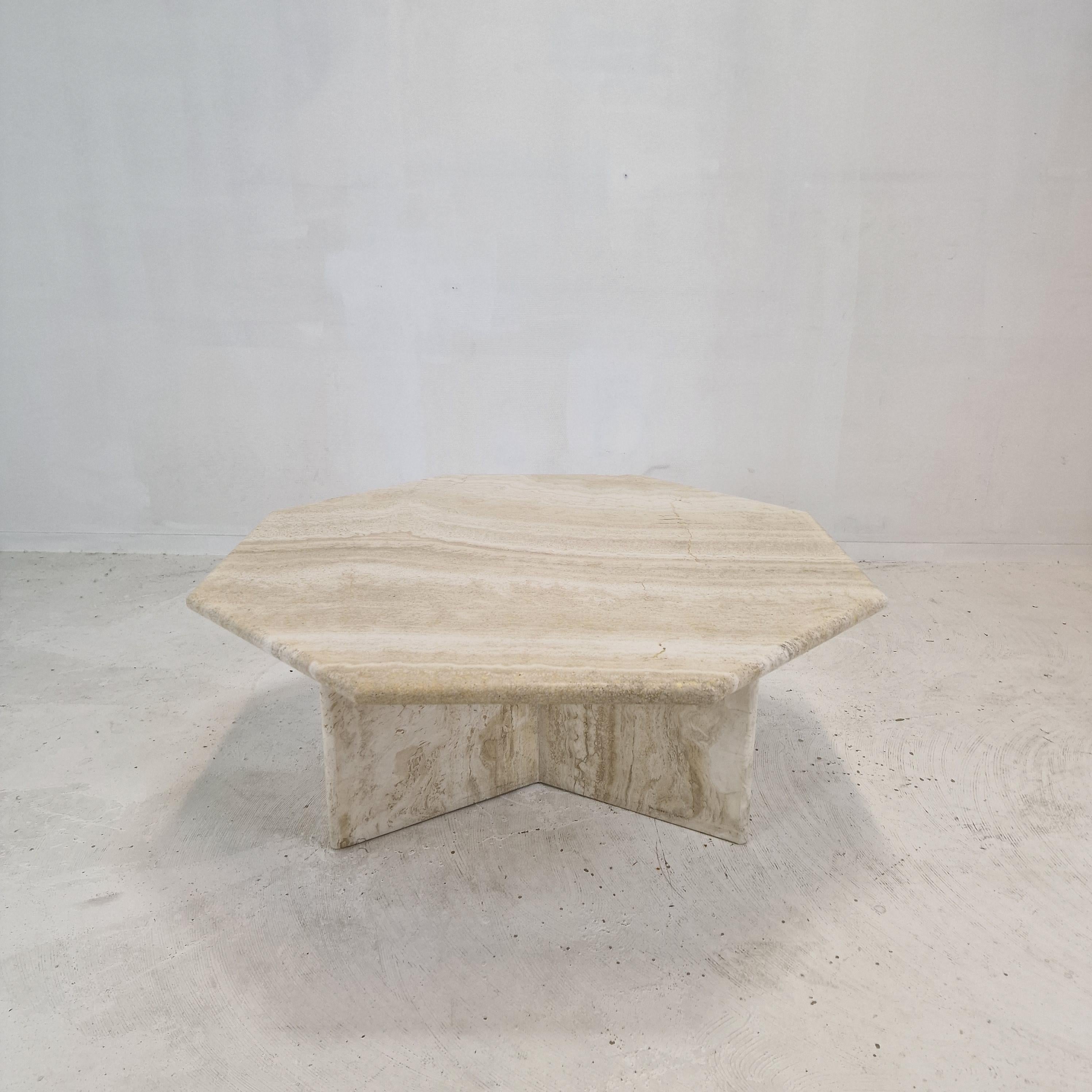 Very nice Italian coffee table handcrafted out of travertine.

The beautiful octagon shaped top is rounded on the edge. 
It is made of beautiful travertine.

The 3-legged base is also made of beautiful travertine.

It has the normal traces of