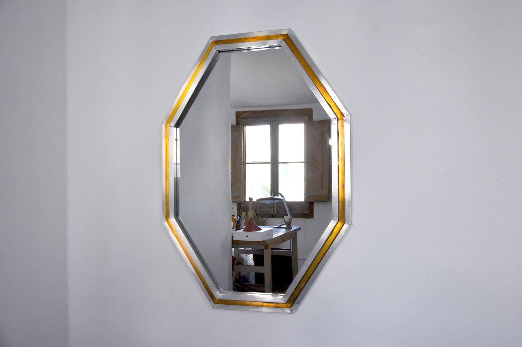 Superb and large octagonal mirror by romeo regga designated and produced in Italy in the 1970s. Brass and metal structure with a superb rare patina design object that will decorate your interior wonderfully. Marks of time relating to the age of the