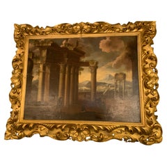 Peinture à l
huile italienne sur panneau représentant des ruines romaines, XIXe siècle, dans un cadre baroque doré