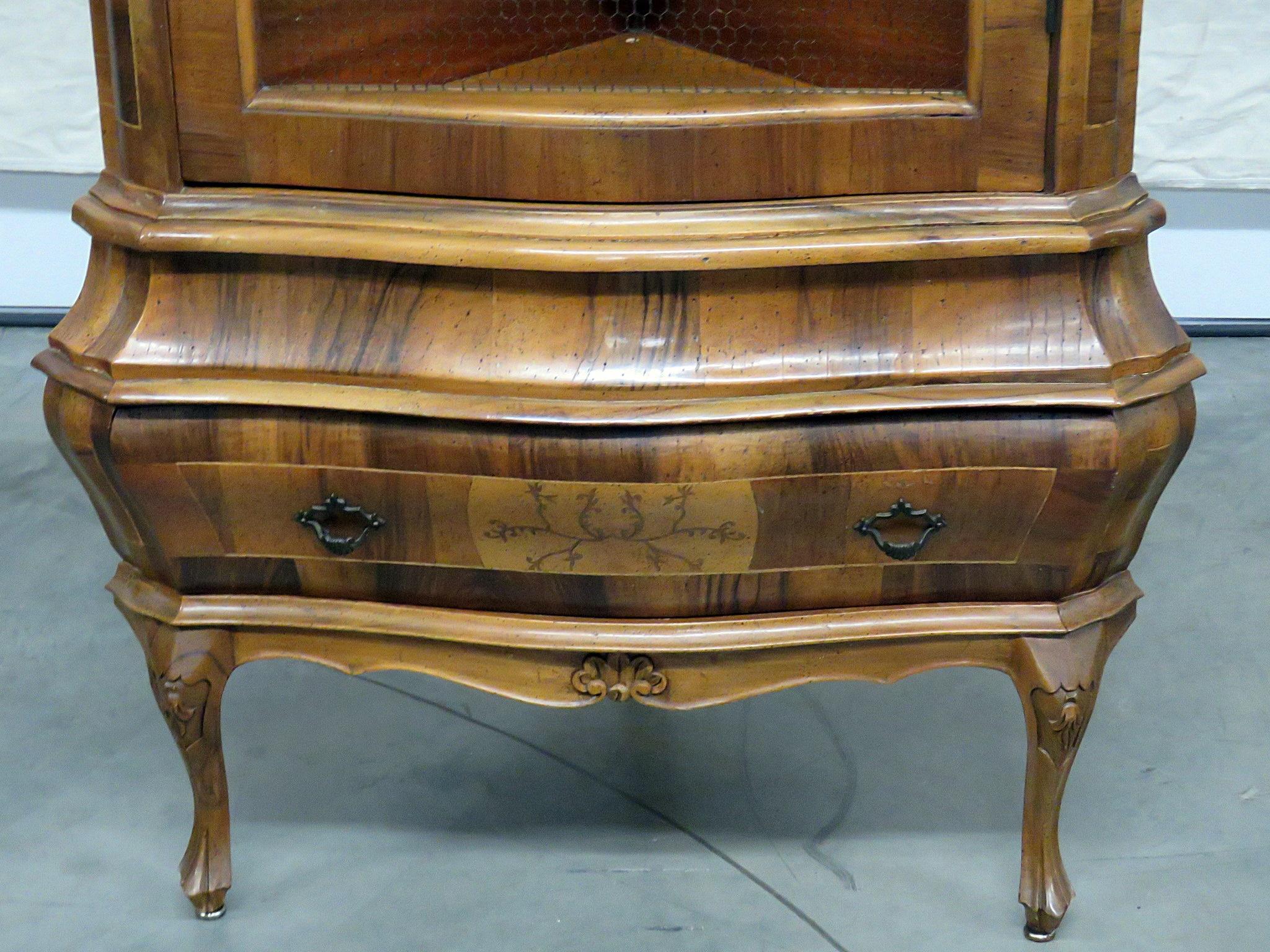 Italian olivewood corner cabinet with 1 door containing 2 shelves over 1 drawer.