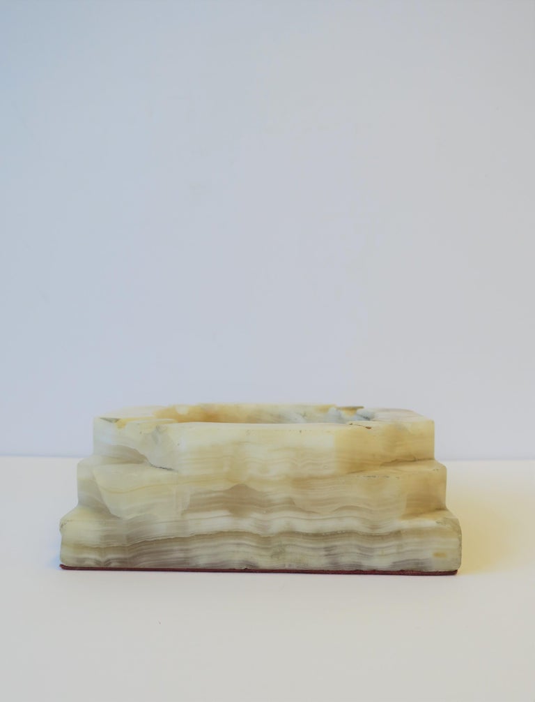 A substantial and relatively large, white to off-white, octagonal onyx ashtray or catch-all vessel (vide-poche), circa 1970s Modern, Italy. A single piece of onyx was use to make this vessel. Onyx colors include: white, off-white, caramel/honey.