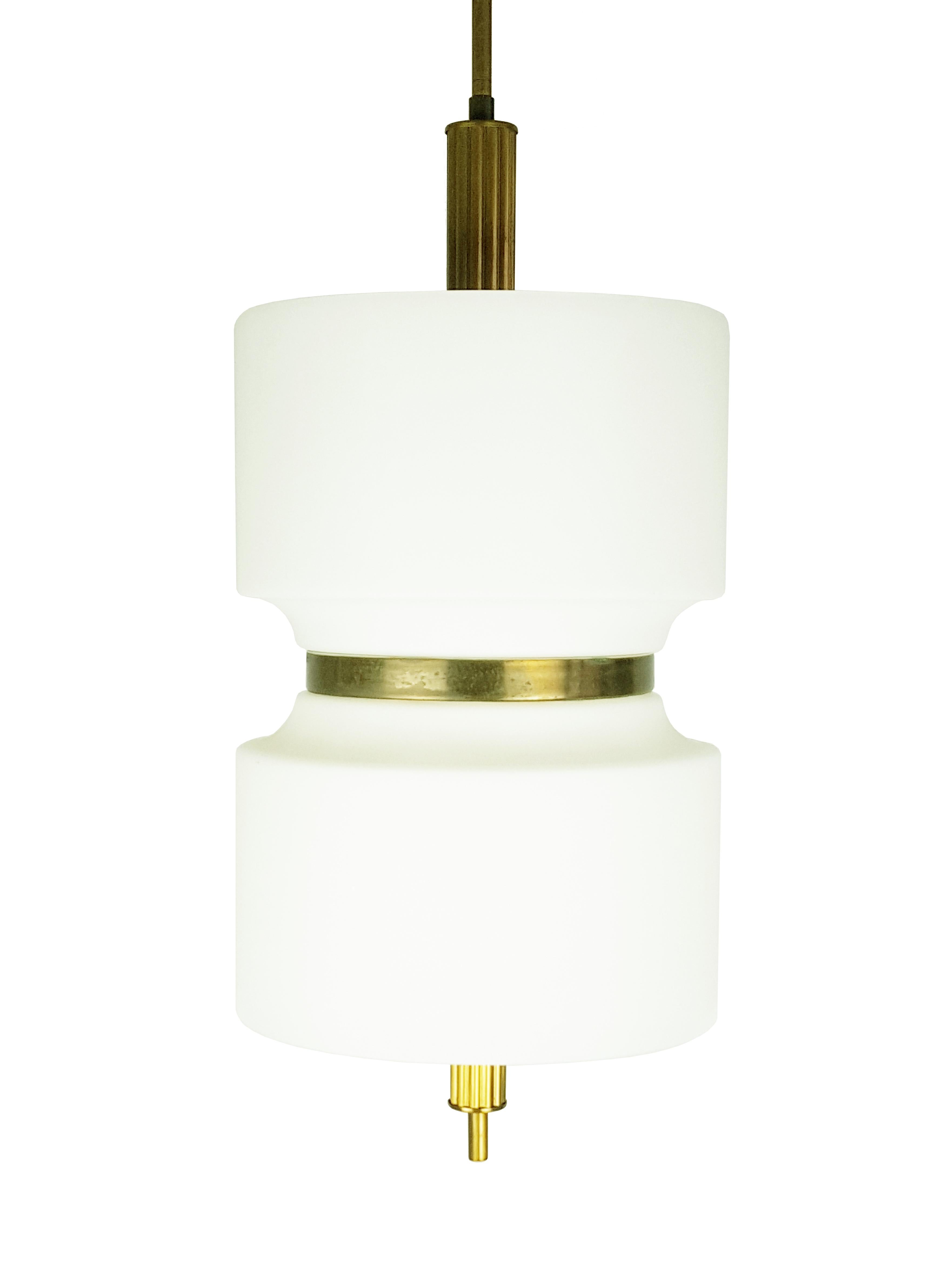 This high quality pendant light was designed by Oscar Torlasco and produced in Italy by Lumi. It is made from two sandblasted glass shades joined together by a brass belt. Each shade features three bulb-lights. Excellent vintage condition.