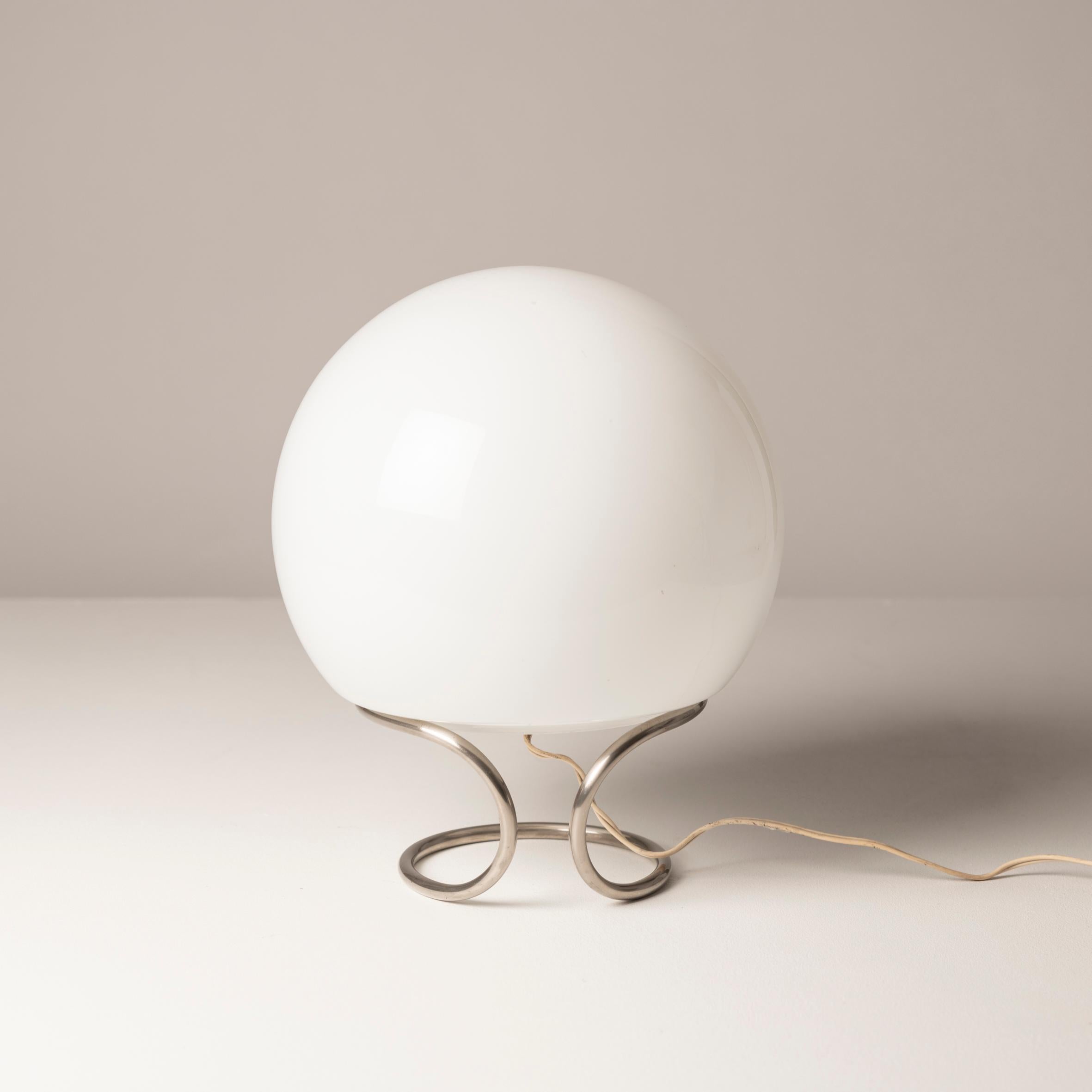Investing in this Italian spheric opaline Table Lamp from the 1960s presents a compelling opportunity to own a piece of mid-century modern design history that effortlessly blends elegance with functionality. The lamp's spheric opaline design exudes