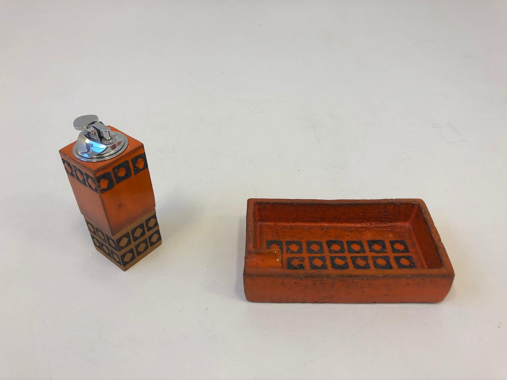 A beautiful 1970s Italian orange with black squares design glazed ceramic smoking set by Bitossi. The lighter inset is polish chrome and the base is wood.
Dimensions: Ashtray-7” wide 4” deep 1.5” high.
Lighter- 2” wide 2” deep 6” high.  
  