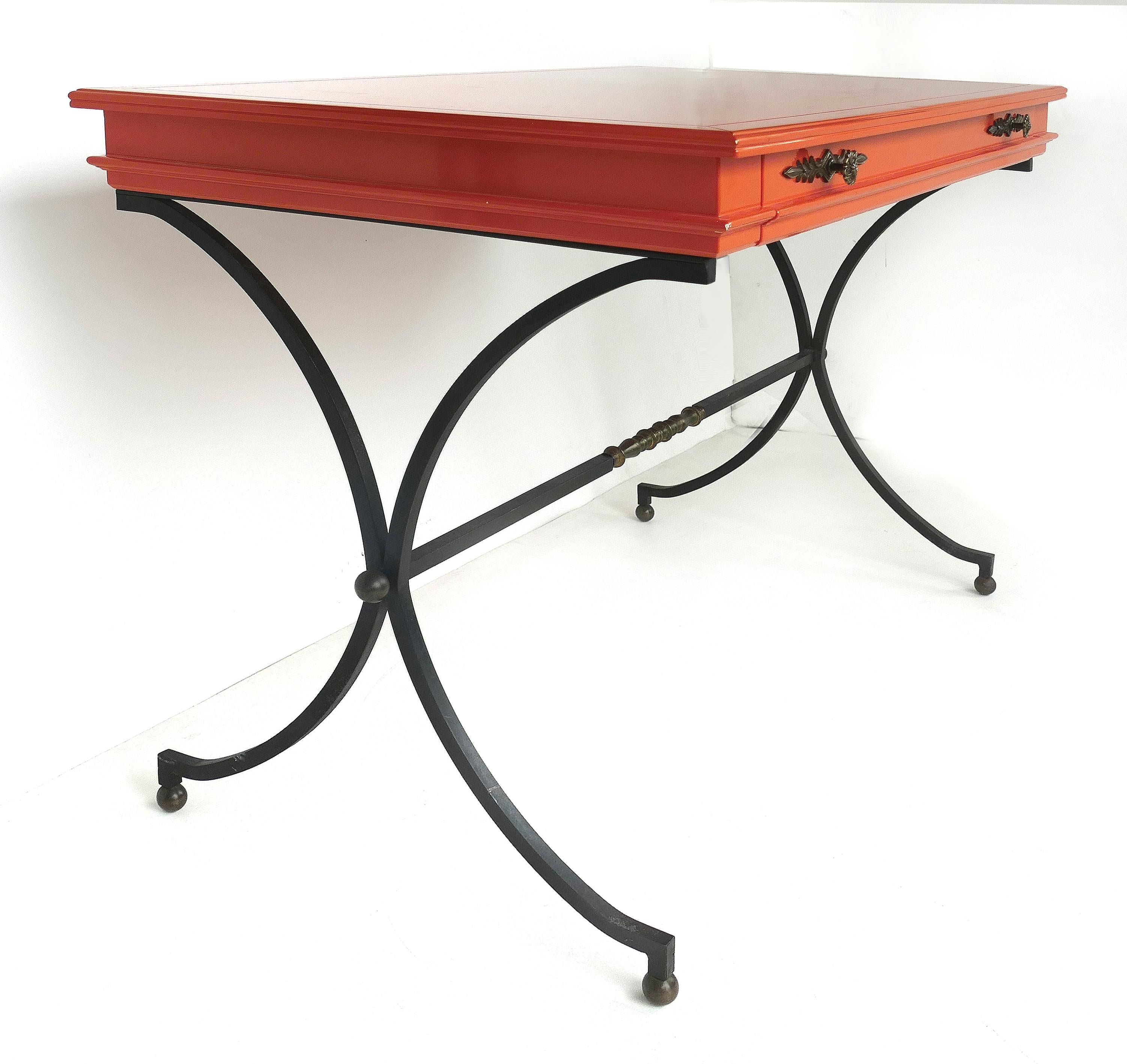 Italian orange lacquer wrought iron desk and chair set

Offered for sale is an Italian Mid-Century Modern lacquered wood and wrought iron writing desk with the original matching desk chair. The desk is finished identically on both sides with a