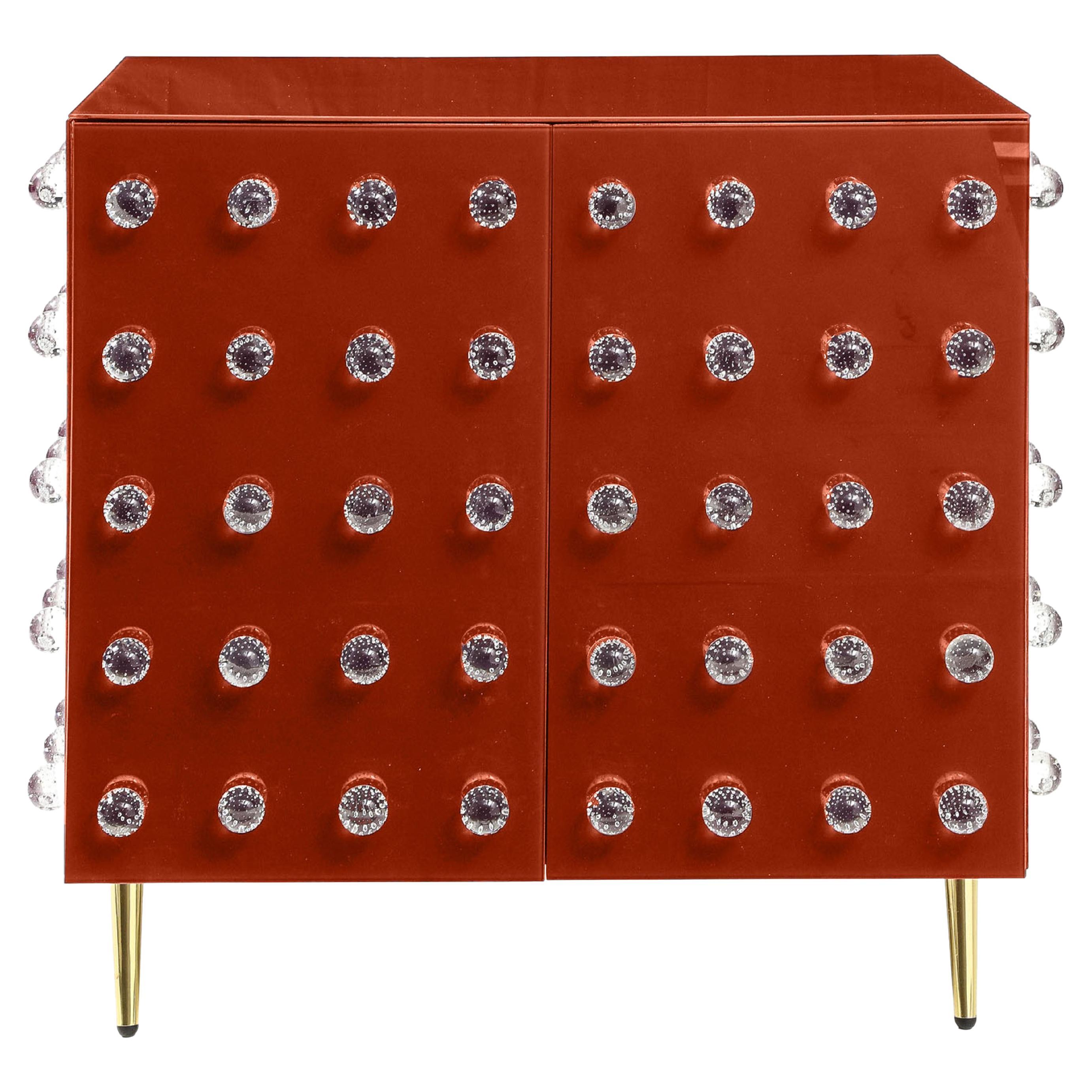 This handcrafted Italian pantry cabinet is a stunning mid-century modern design featuring vibrant orange panels and ninety Murano glass spheres. 

Made of solid birch wood, it is a demonstration of fine Italian craftsmanship. The furniture's clean