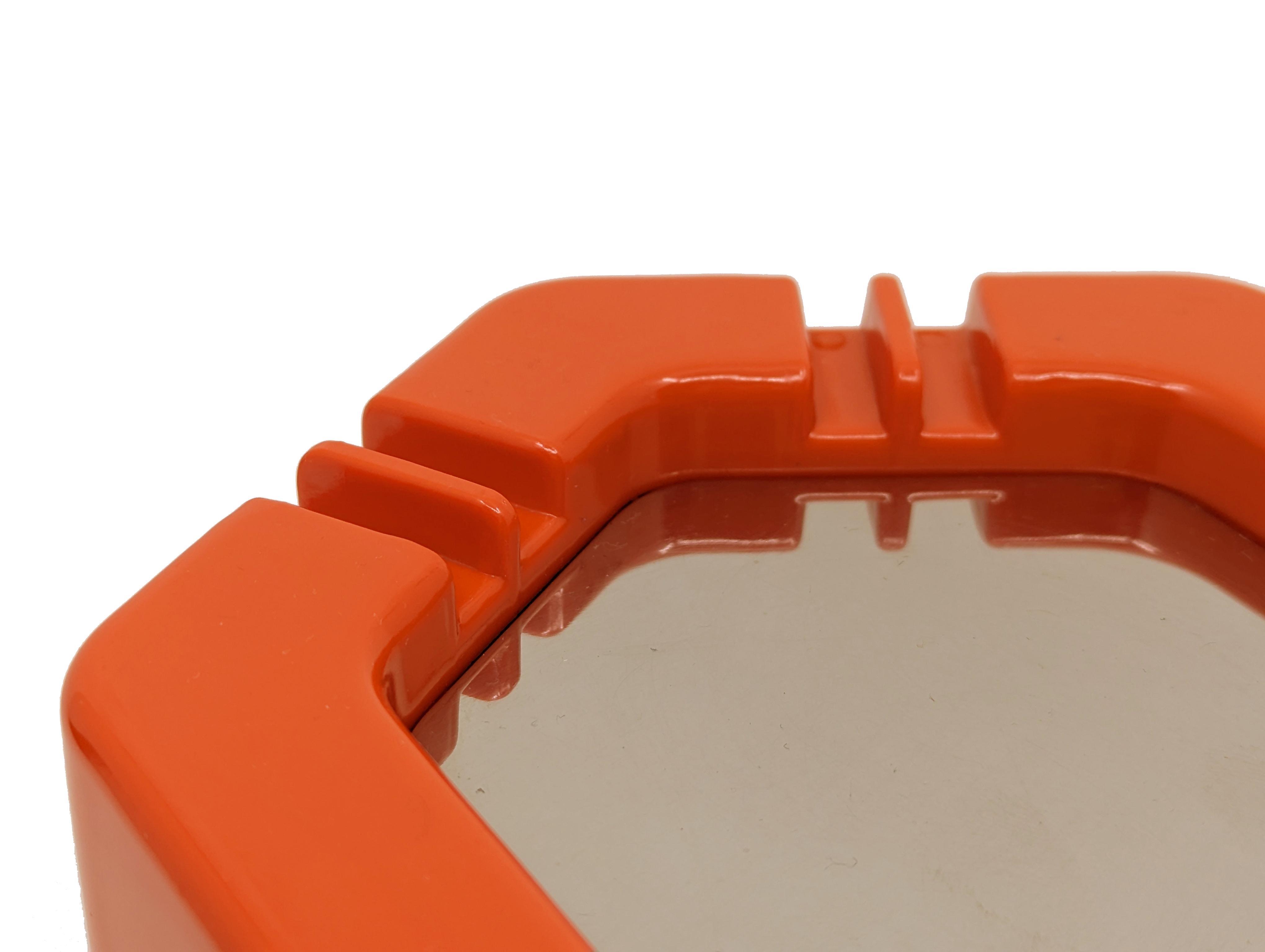 
Large table ashtray in orange plastic with chrome plated pivotable lid. 
Very good condition.
