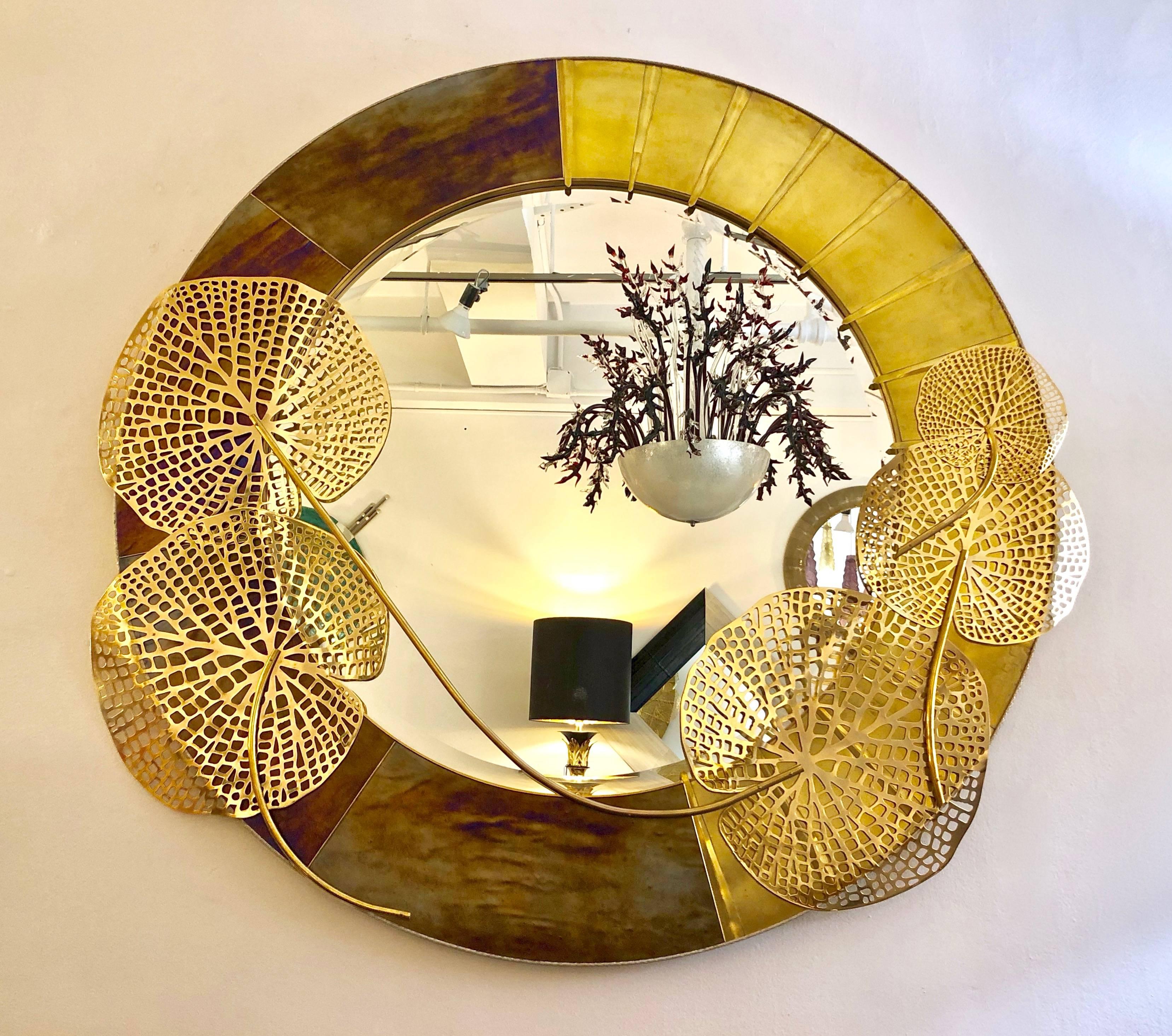 Exclusive Art Deco design by Cosulich Interiors, contemporary Italian fine Design bespoke wall mirror, nature inspired sculpture, entirely handcrafted with a substantial brass frame, finished on one side with an iridescent Murano glass worked