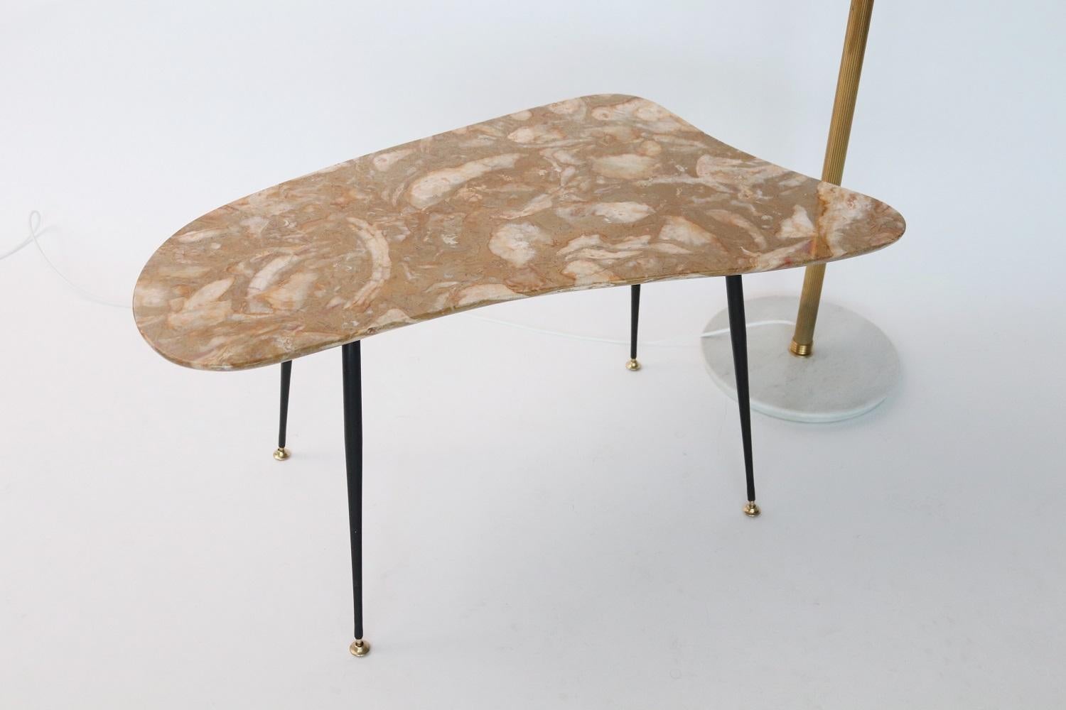 Beautiful coffee table with gorgeous elegant marble top in yellow moutarde color, organic shape and metallic legs with brass tips.
The edges are soft rounded, typically done in the midcentury.
Made in Italy during the 1950s.
The marble is