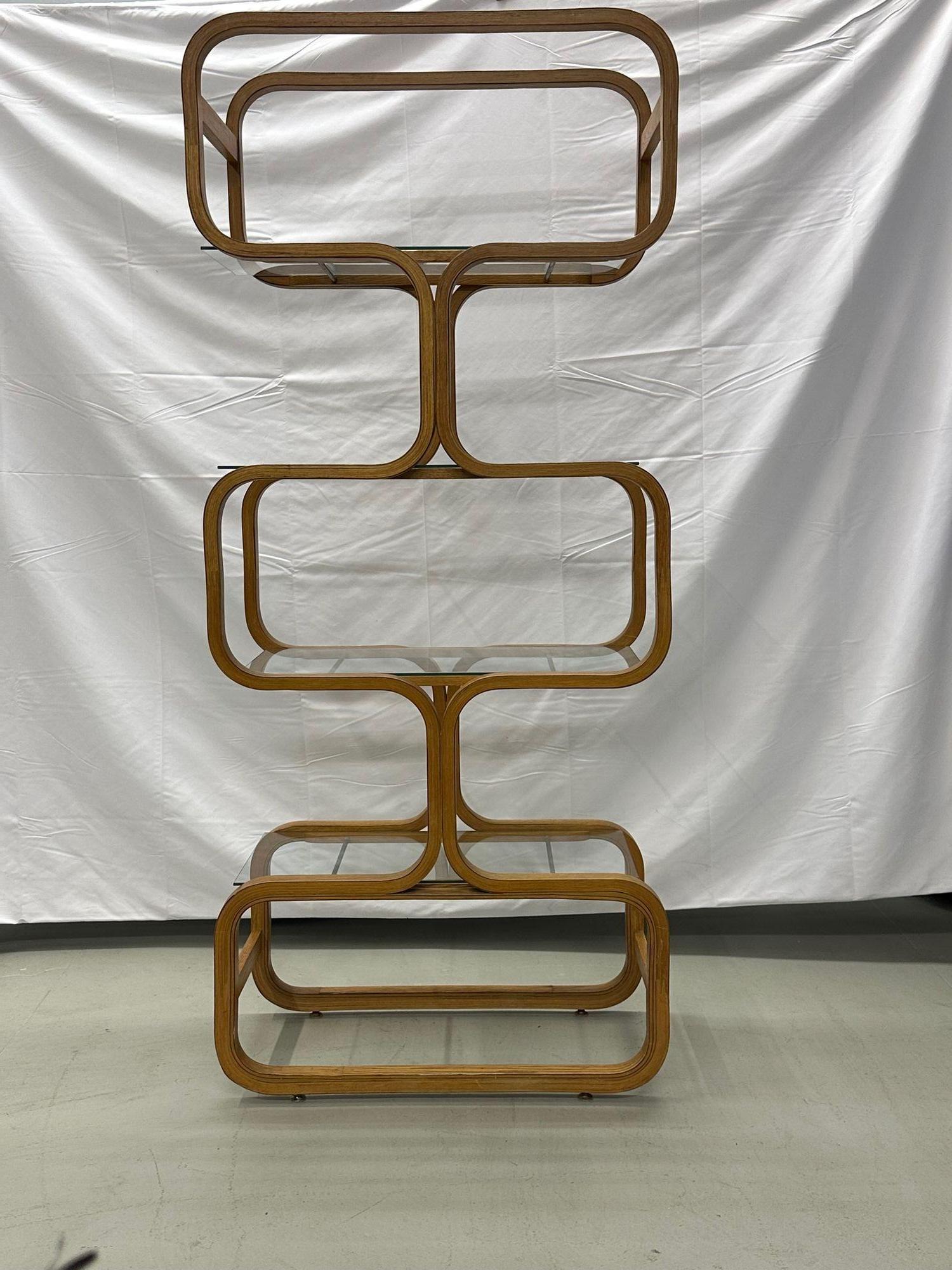 Italian Organic form Mid-Century Modern bentwood bookshelf / etagere by Plycraft
 
Playful shelving unit comprised of bentwood, glass, and brass rods. Manufactured by Plycraft during the midcentury time period. Organic curvy lines. Each glass