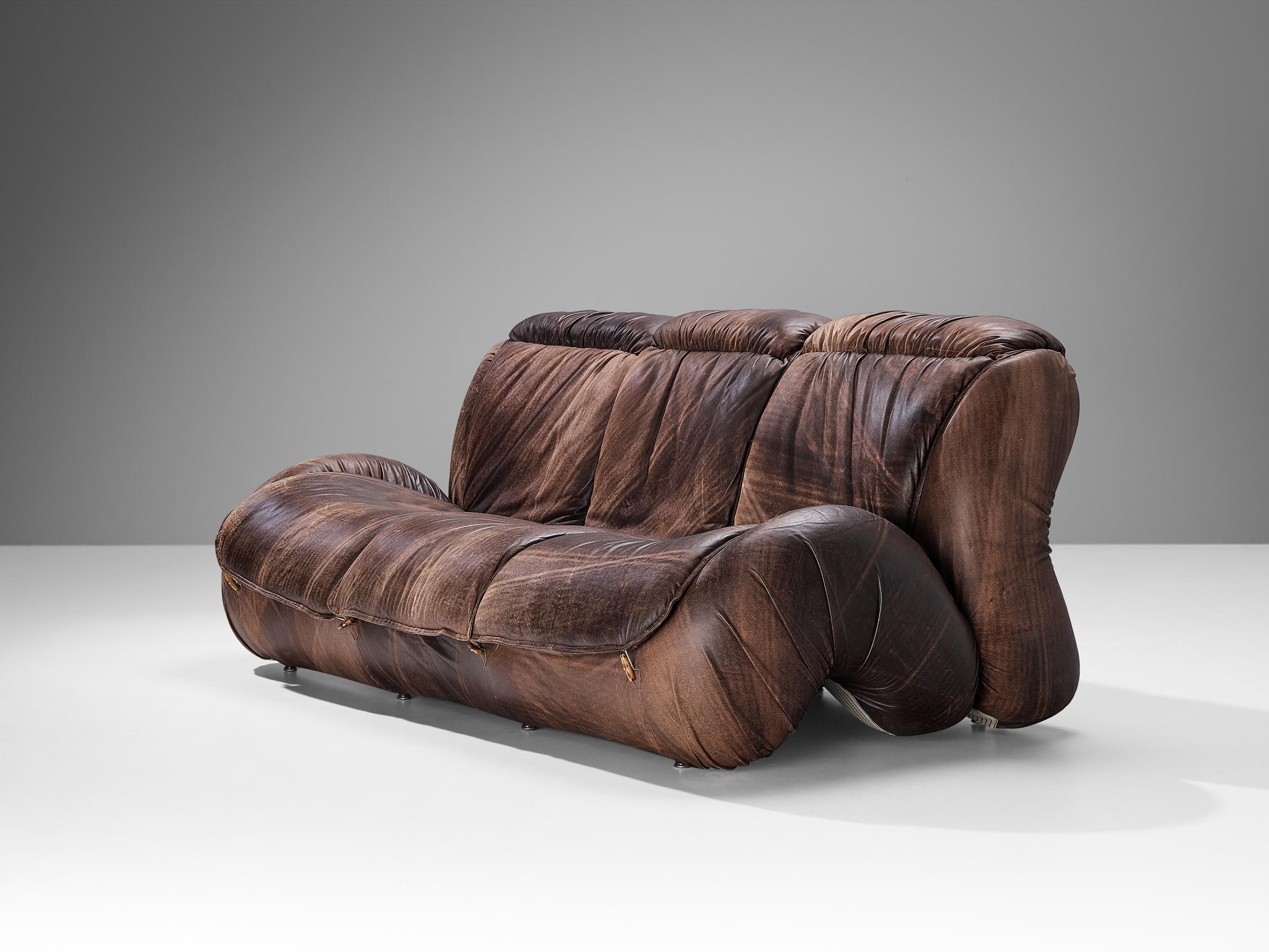 Sofa, beech, leather, Italy, 1970s. 

This postmodern Italian sofa will surely grab the viewer's attention. The construction is based on enlarged biomorphic shapes with curvaceous lines and bold shapes dominating the layout. The top layer of the