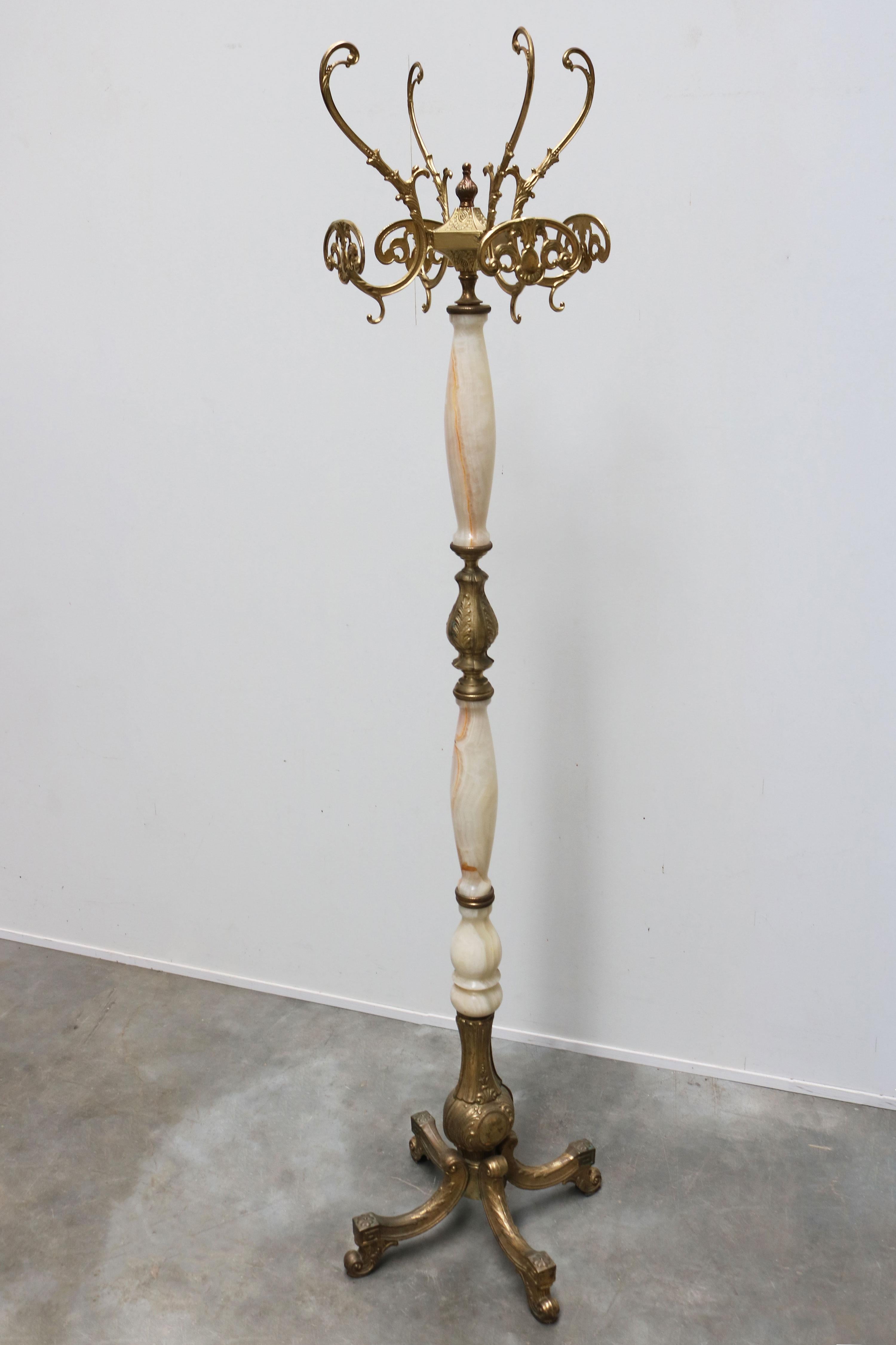 Italian Ornate Antique Brass & Onyx Round Marble Coat Hat Rack Hall Tree 1940s

This high quality freestanding, ornate hall tree dates to the 1940s.
It is crafted from round onyx marble and brass and has numerous beautiful details.
With a big