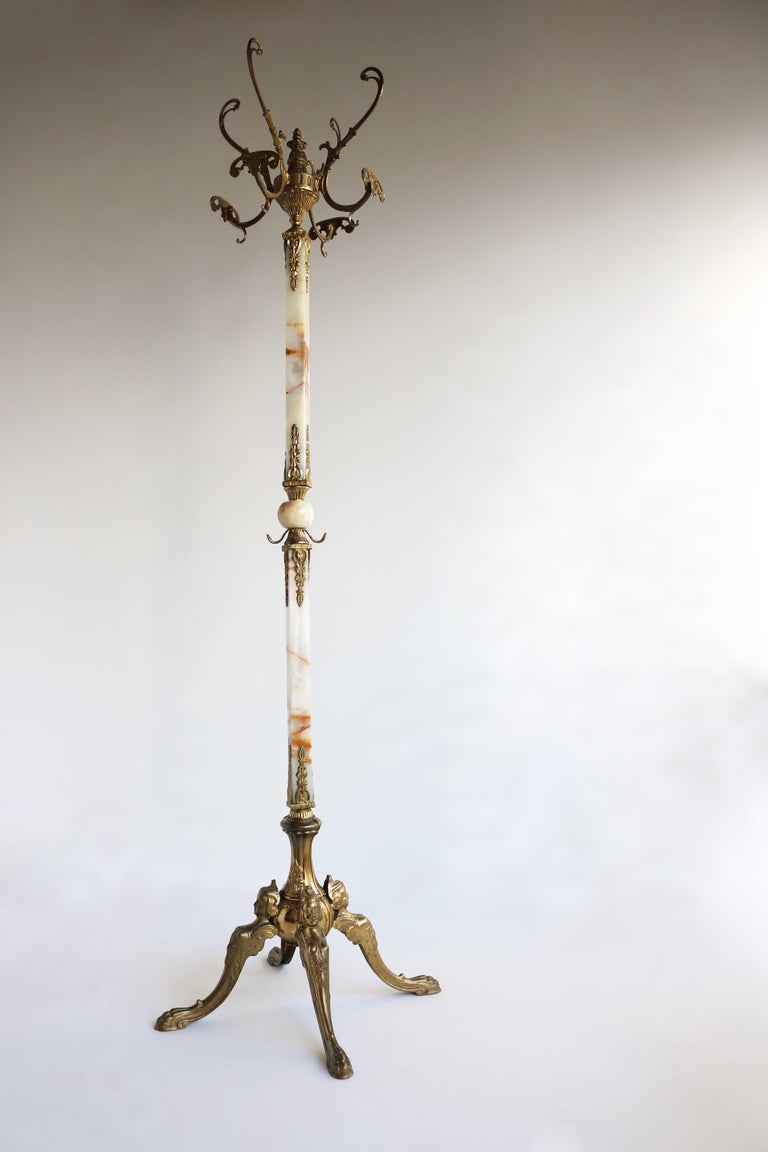 Italian ornate antique brass & onyx square marble coat hat rack hall tree stand Hollywood Regency Eye catcher Classic 60s

This high quality free standing, ornate hall tree dates to the 1960's.
Very lovely square and round marble! 
The beautiful