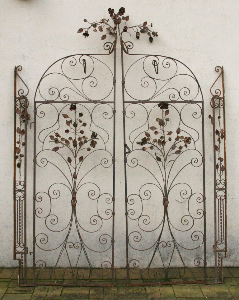 Italian hand crafted garden gates with flowers and leaves.Two main gates with 2 side panels.
Some old paint remaining on the flowers.
Main panels each 24