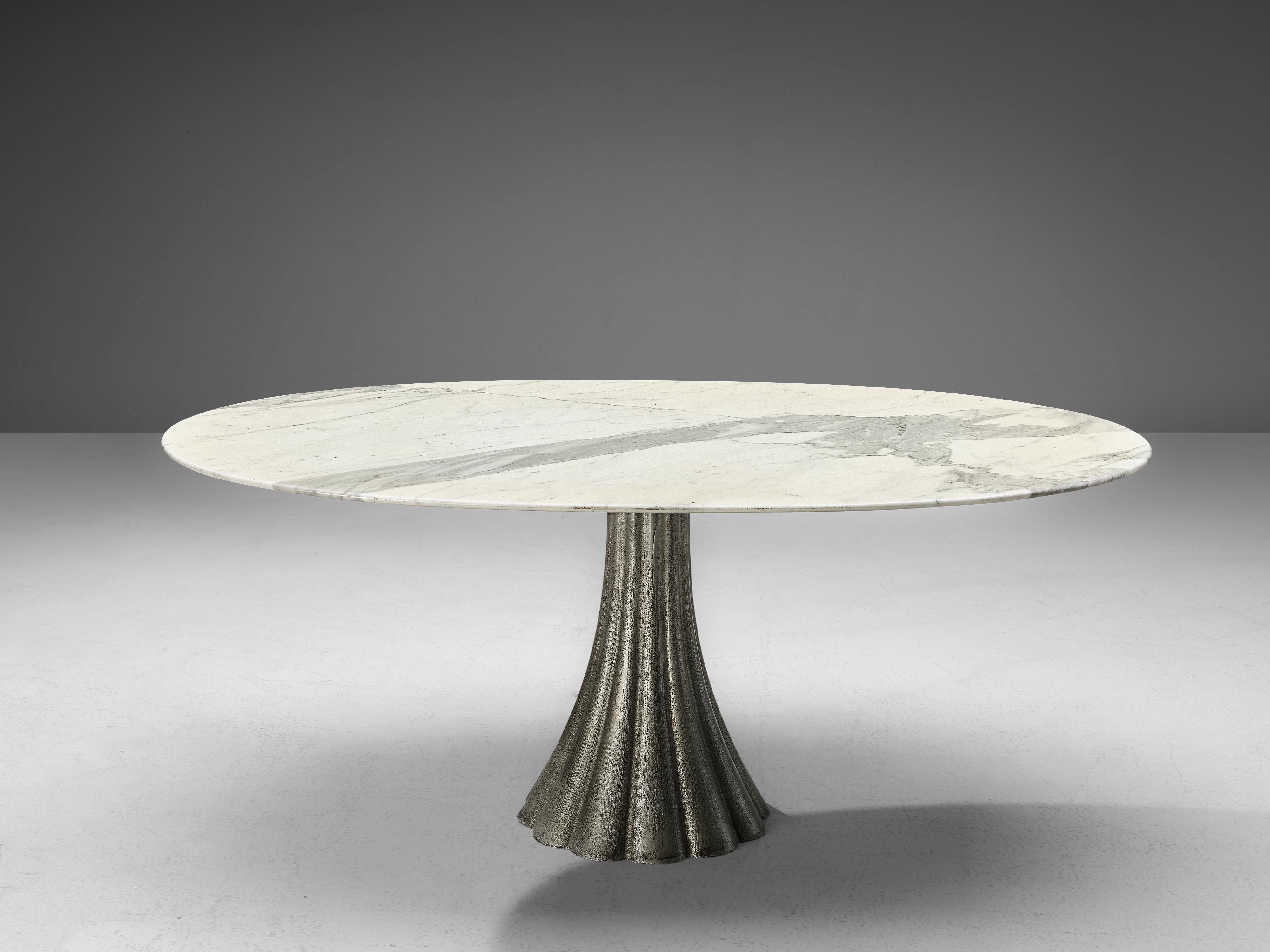 Oval dining table, marble, steel, Italy, 1960s

The oval shaped tabletop shows a beautiful play of natural grey and white colors. The pedestal table is constructed with a scalloped shaped base, made out of steel. The flared base is tapered towards