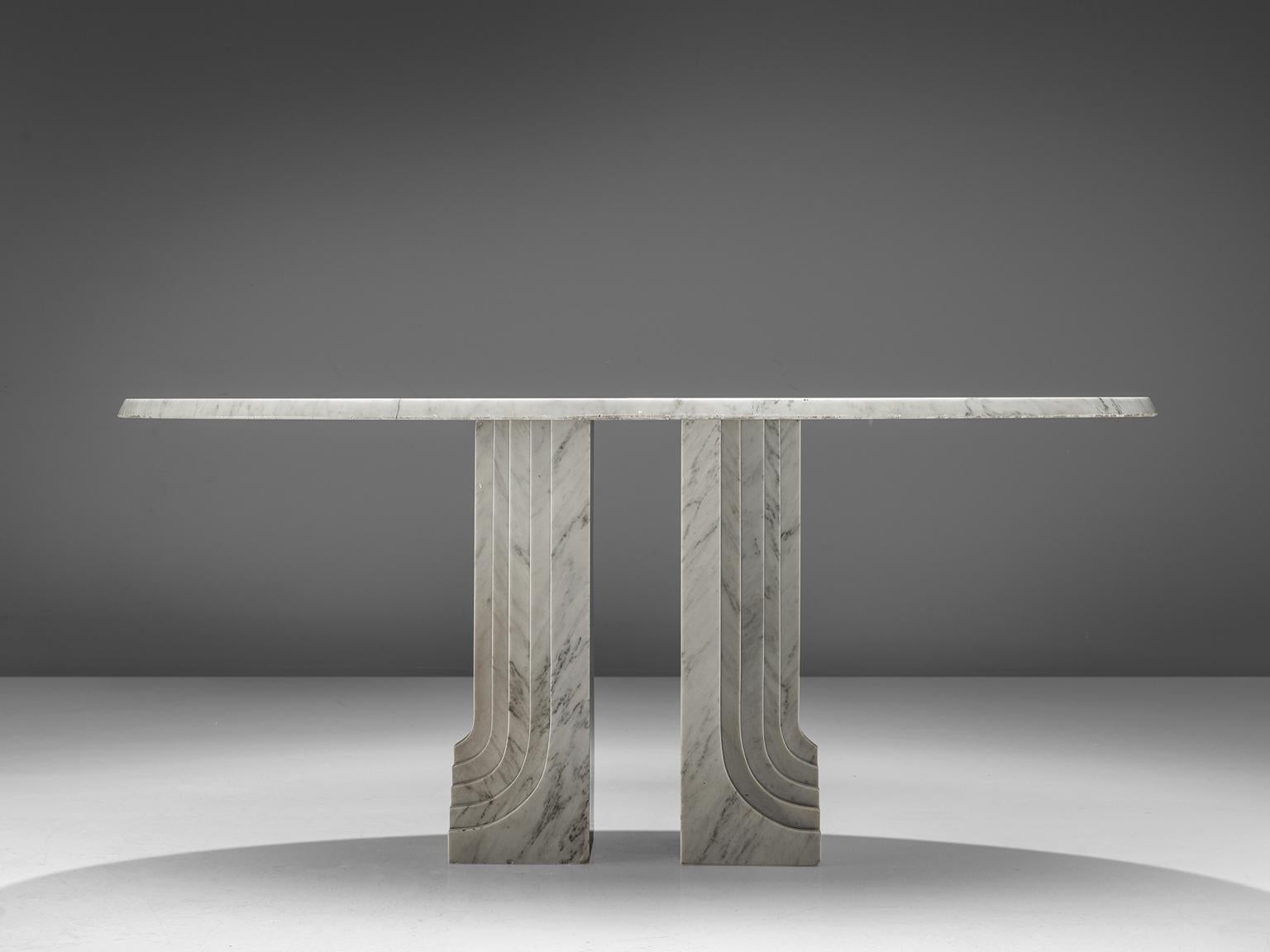 Oval marble table, Italy, 1970s.

This table is an nice example of Italian design with roman inspired architecture. The base of the table is formed out of two layered pillars that exist of several pillars in a row. The oval tabletop stretches out