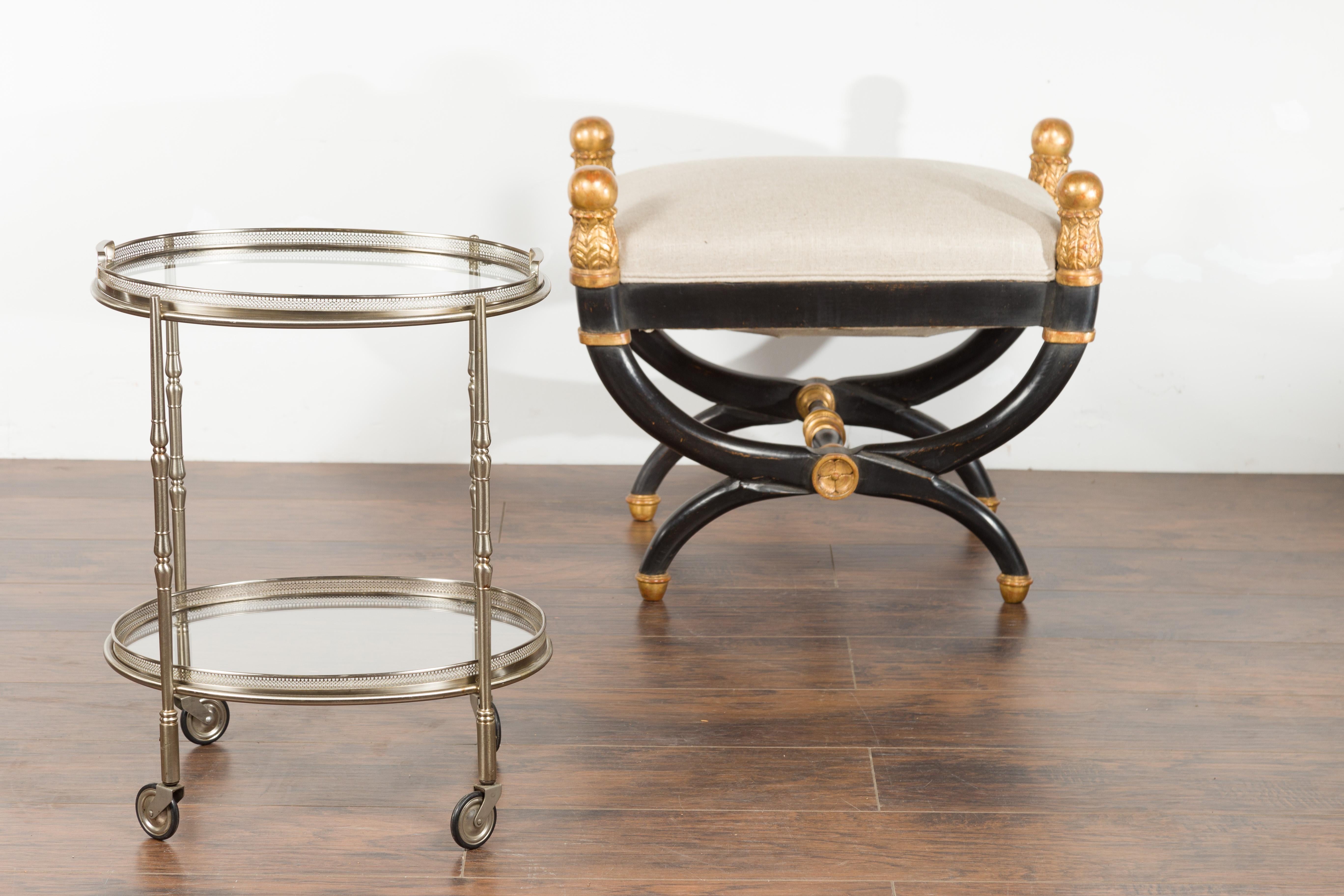 A vintage Italian oval steel trolley from the mid-20th century, with pierced gallery, mirrored shelves and casters. Created in Italy during the midcentury period, this steel trolley features an oval mirrored top surrounded by a delicately pierced