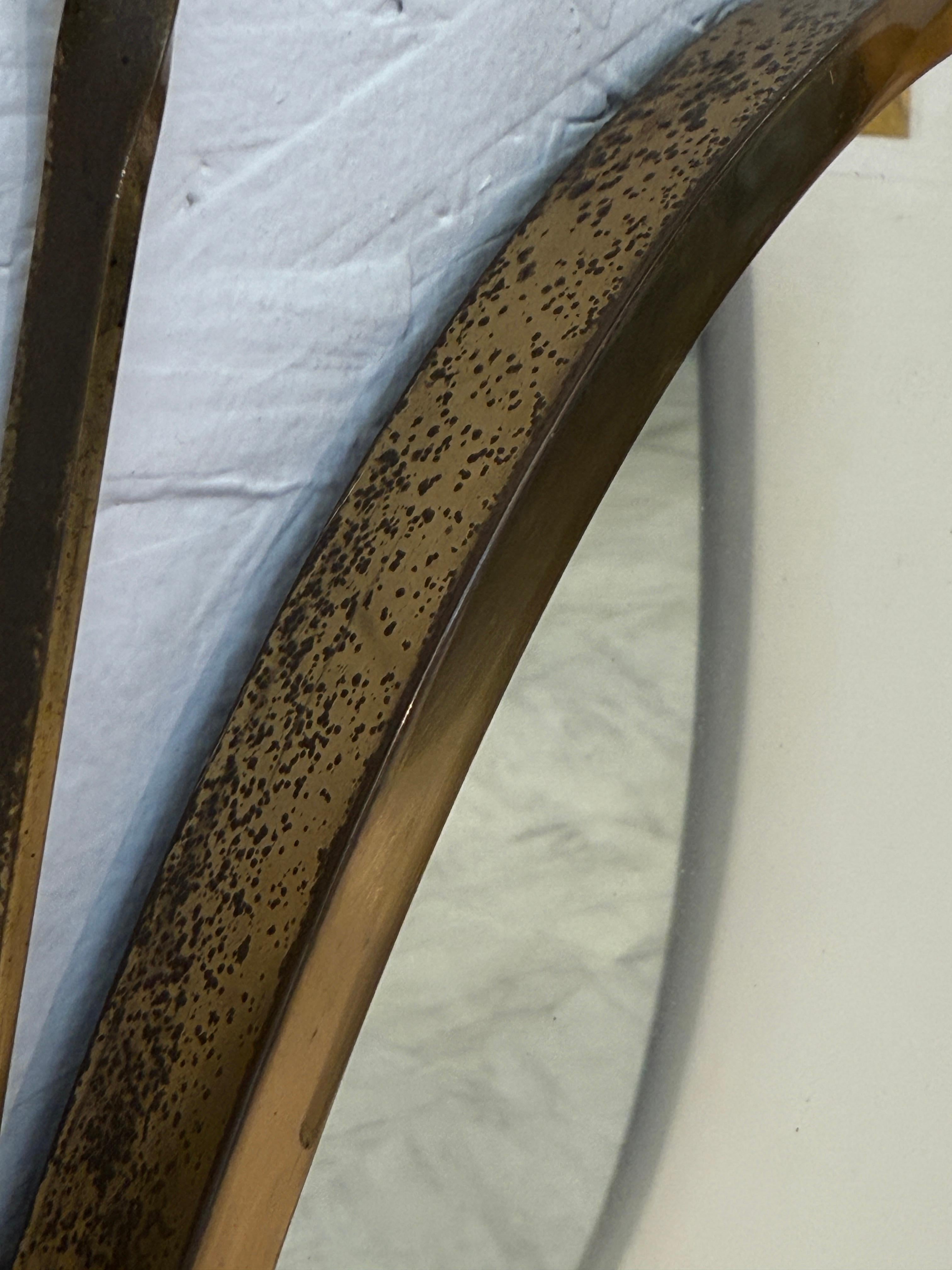 Metà XX secolo Italian oval mirror from the 1950s, featuring a brass frame suspended by a twist in vendita