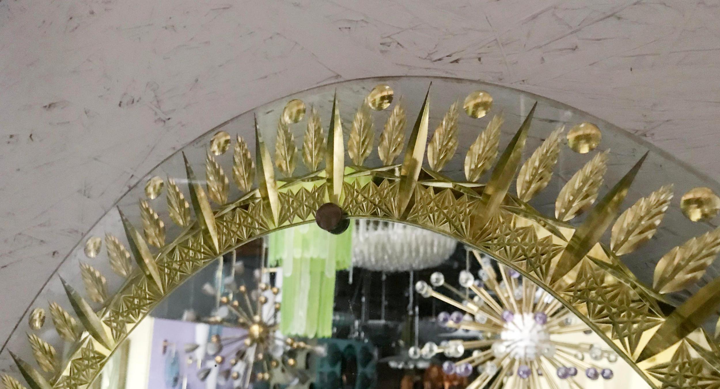 Italienischer ovaler Spiegel mit klarem, abgeschrägtem Glas, verziert und graviert mit Blattgold, entworfen von Cristal Arte, hergestellt in Italien in den 1950er Jahren.