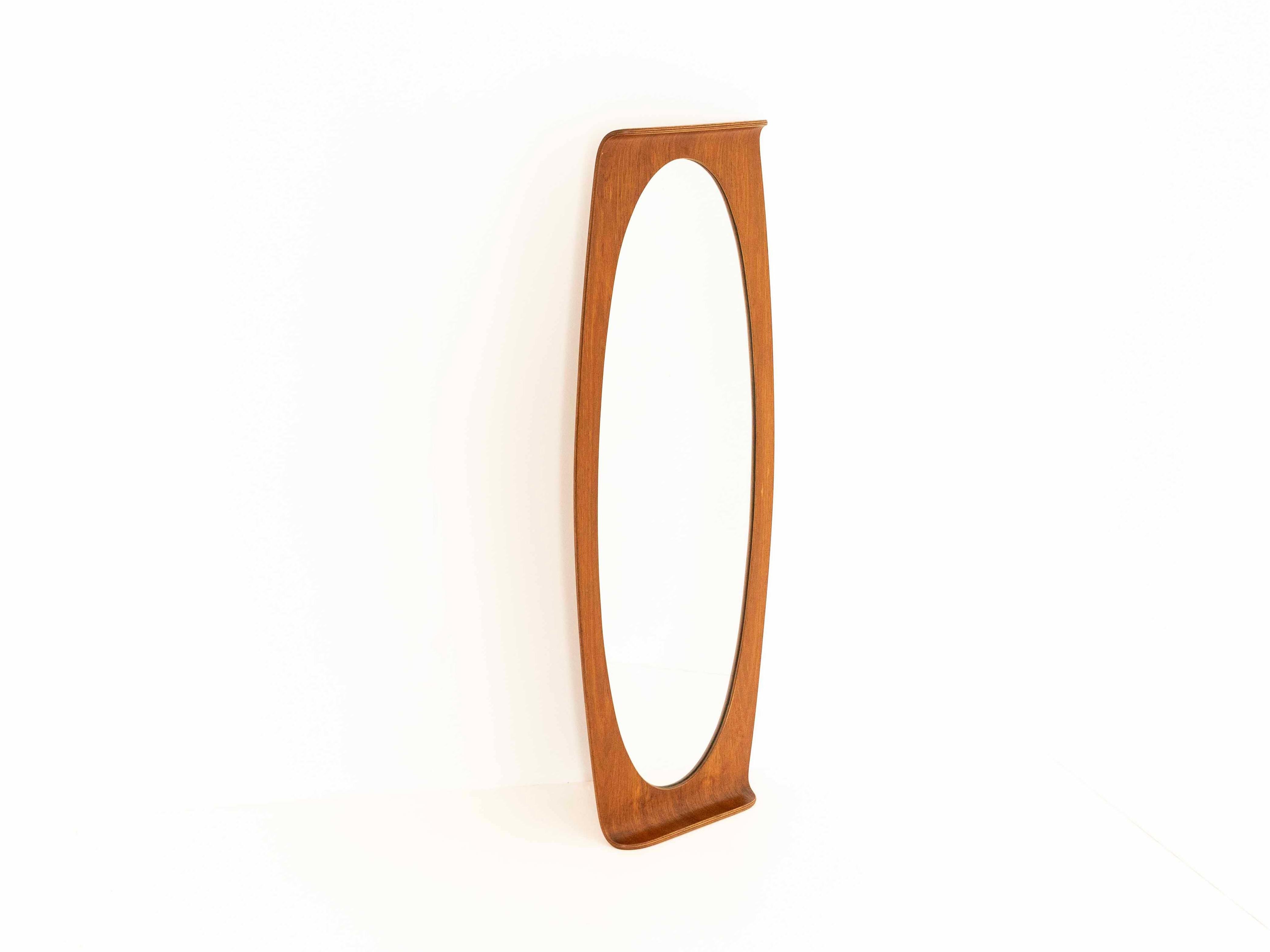Beautiful large Italian Oval curved Plywood (teak) mirror by Campo & Graffi for home - manufactured in the 60's. It has a small curve at the top and bottom of the mirror. The mirror is in good condition with normal wear and tear due to its age. With