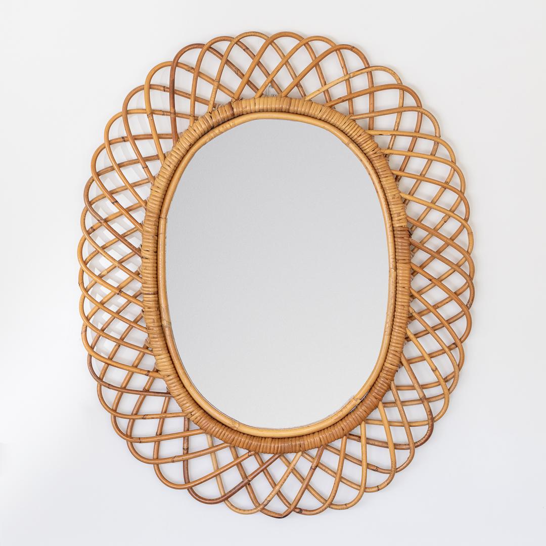 Beautiful oval rattan mirror by of Franco Albini from Italy, 1960's. Great size, perfect for bathroom or entryway. Nice vintage condition with original rattan frame and mirror.