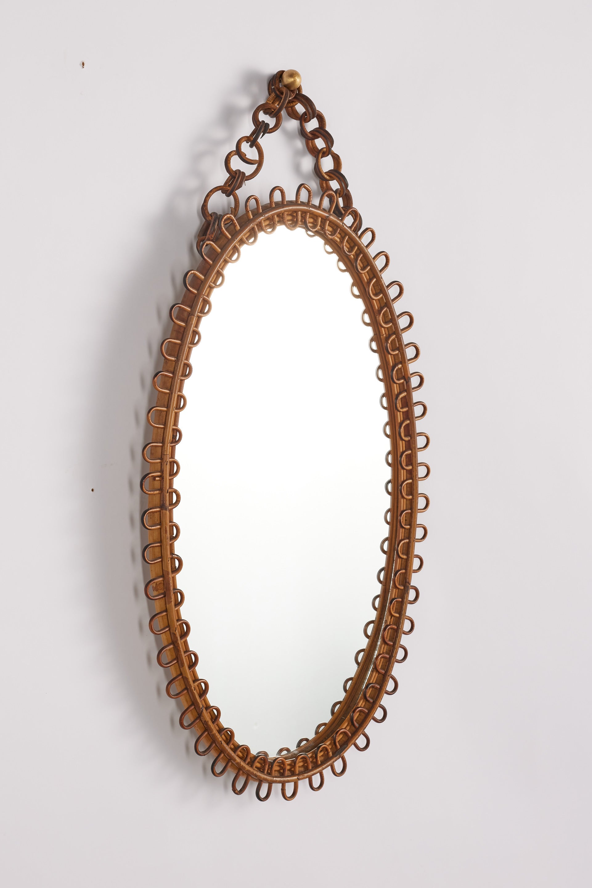 Whimsical Italian bamboo mirror with looped rattan frame. 

Wonderful patina throughout. 

Italy, 1960s.