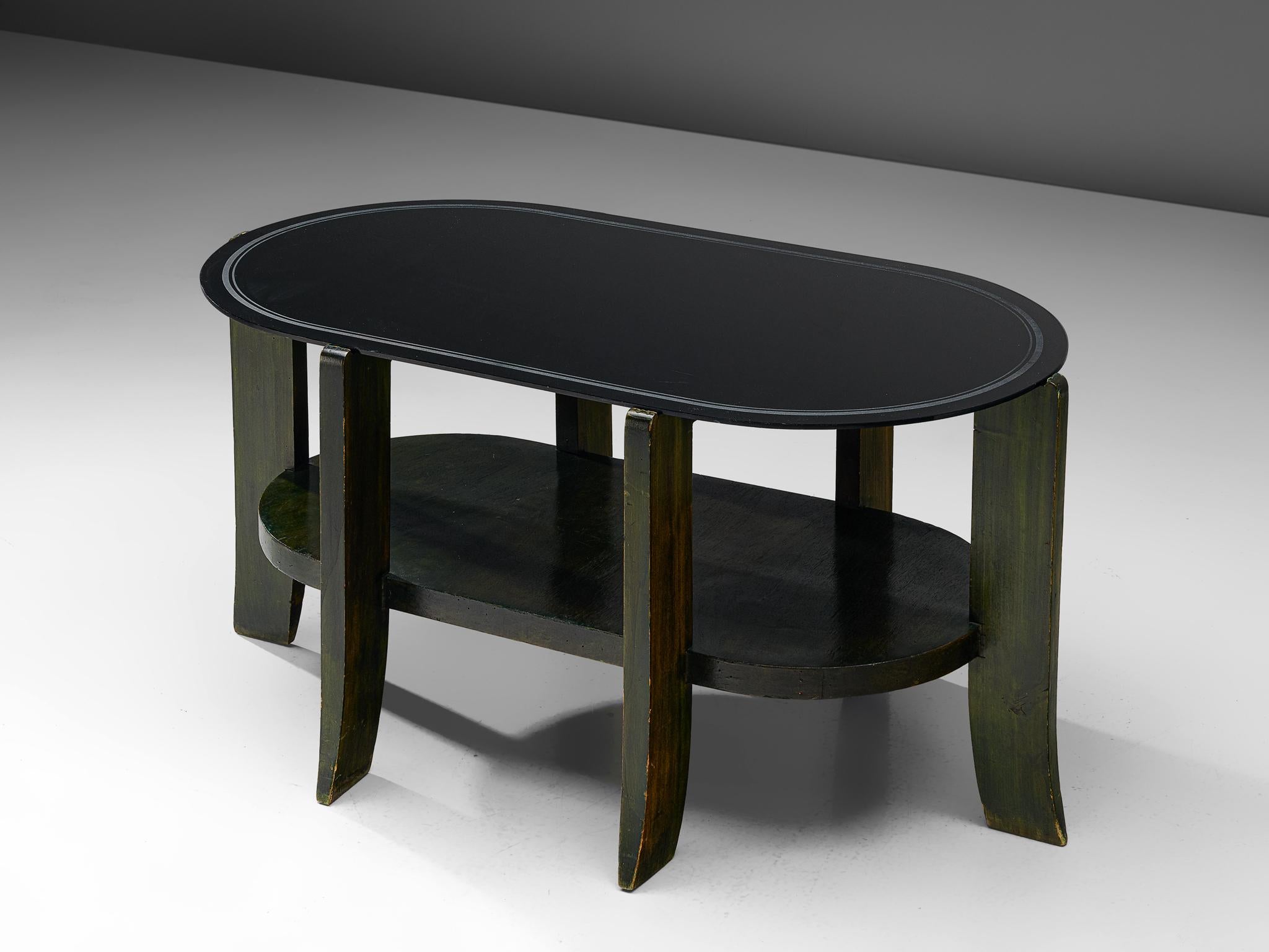 Coffee table, wood and glass, Italy, 1950s

An oval shaped coffee table with a black glass top. The glass rests on six robust legs that form the base. The legs are sturdy and turn slighlt outwards near the bottom. The wooden base is dark green