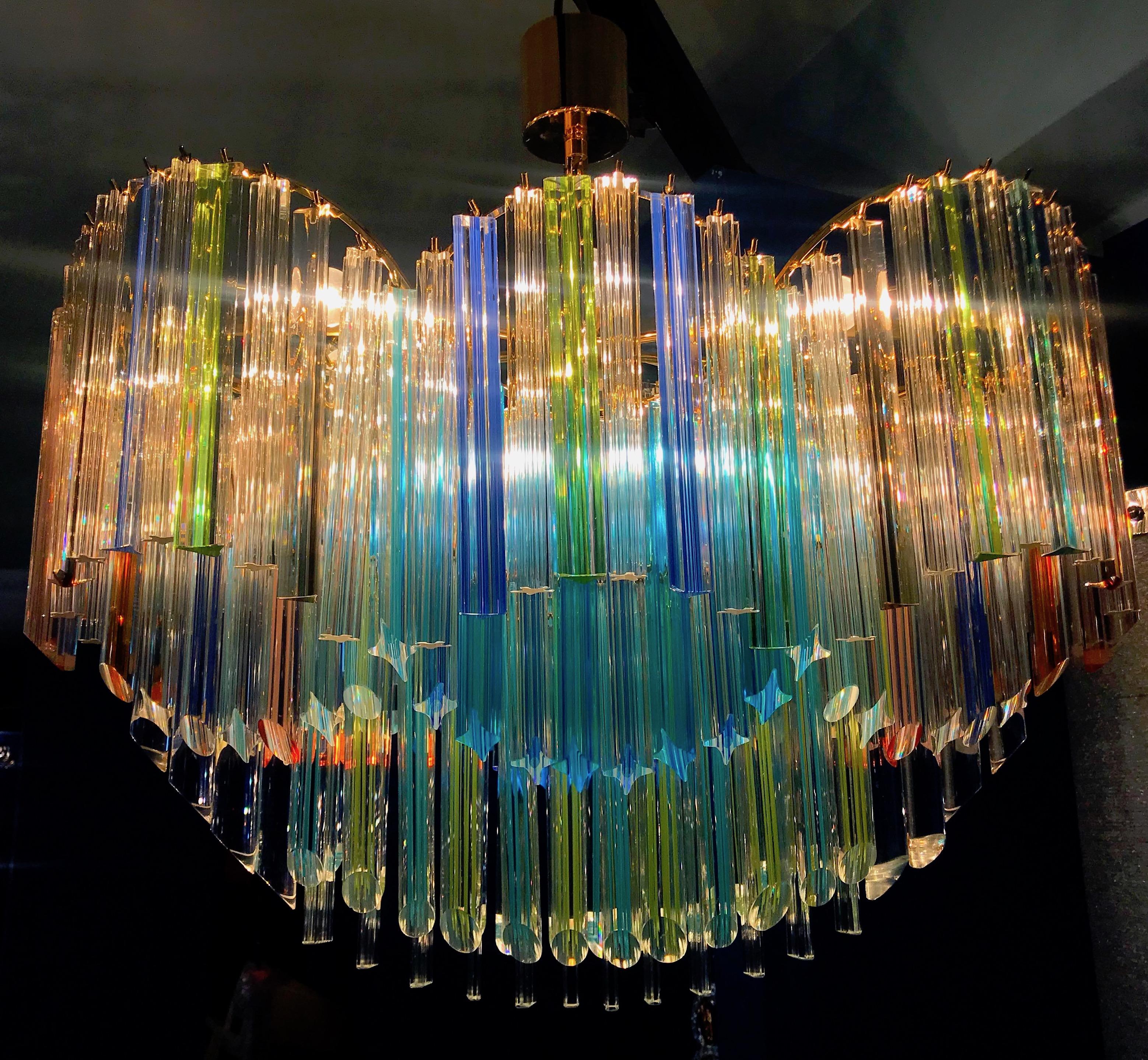 Outstanding unique vintage Murano chandelier made by Murano crystal multicolored prism on four levels with a gold metal frame.
The glasses are Aquamarine , transparent, blue, smoky, purple, green, yellow , pink and orange , creating a fabulous