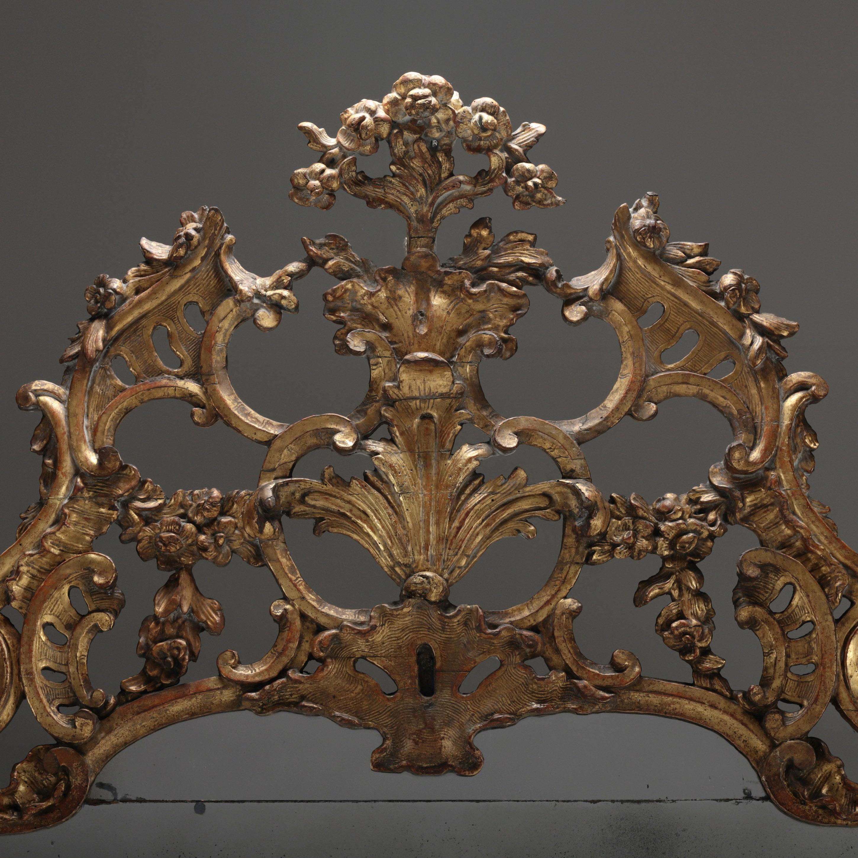 A NORTH ITALIAN OVERMANTEL MIRROR, CIRCA 1770
Of conventional rectangular landscape form with original mercury silvered plates, separated by gilt wood borders with beaded detail finished with a dramatic rococo style crest.
Height: 134cm
Width: