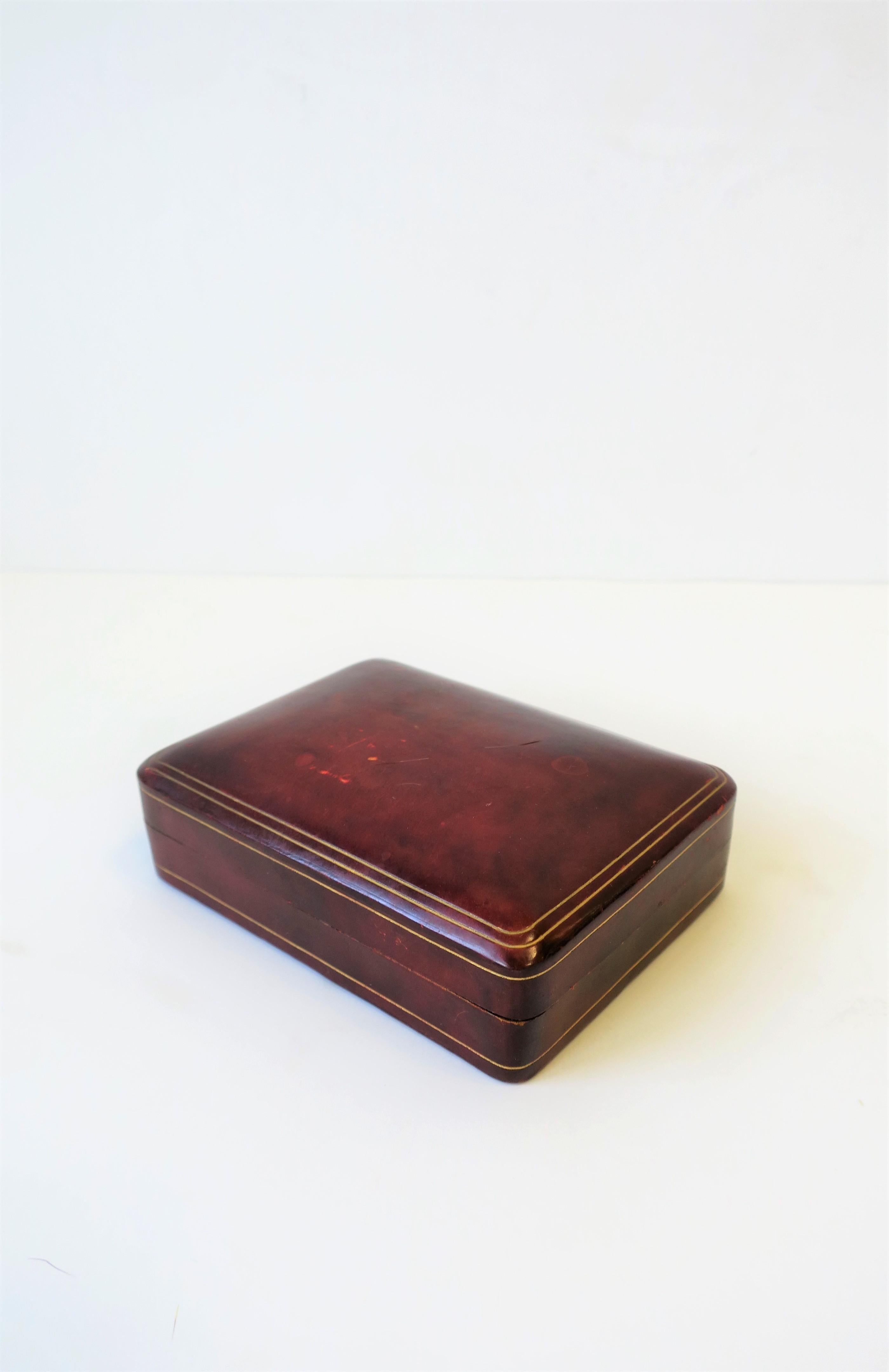 A beautiful midcentury Italian red burgundy 'ox blood' leather box with gold embossing. Marked 'MADE IN ITALY