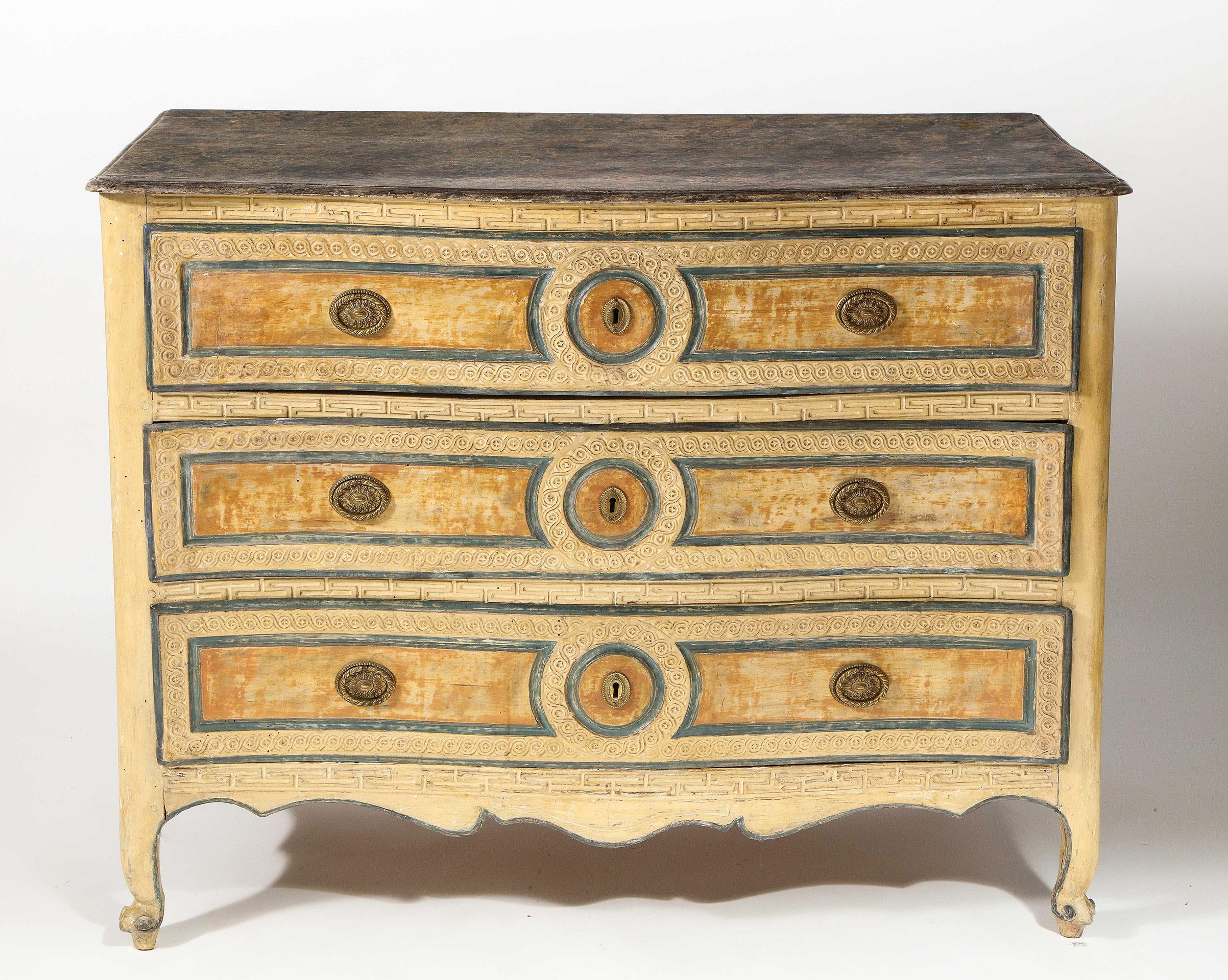 The all-over painted commode with a faux marble top, the front having an incised Greek key design separating 3 drawers, each with incised interlocking scroll work. 

Some paint refreshed.