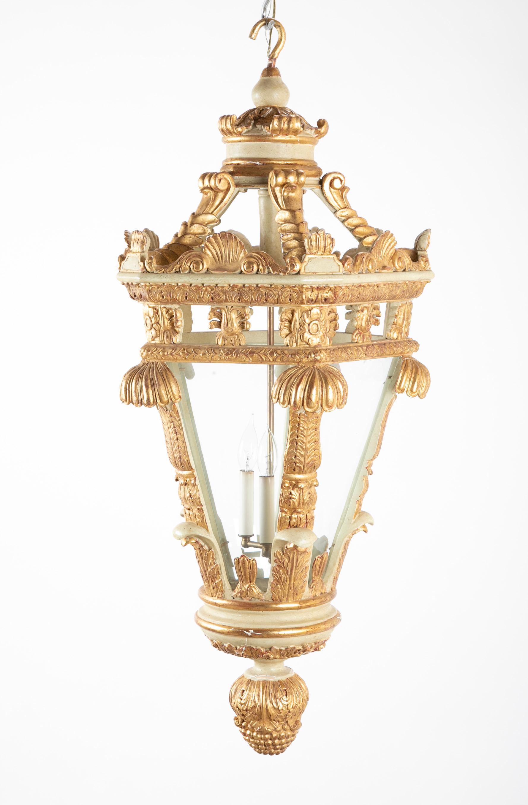 Italian painted and gilded five-sided lantern with shell and scroll carvings and elaborate finial.