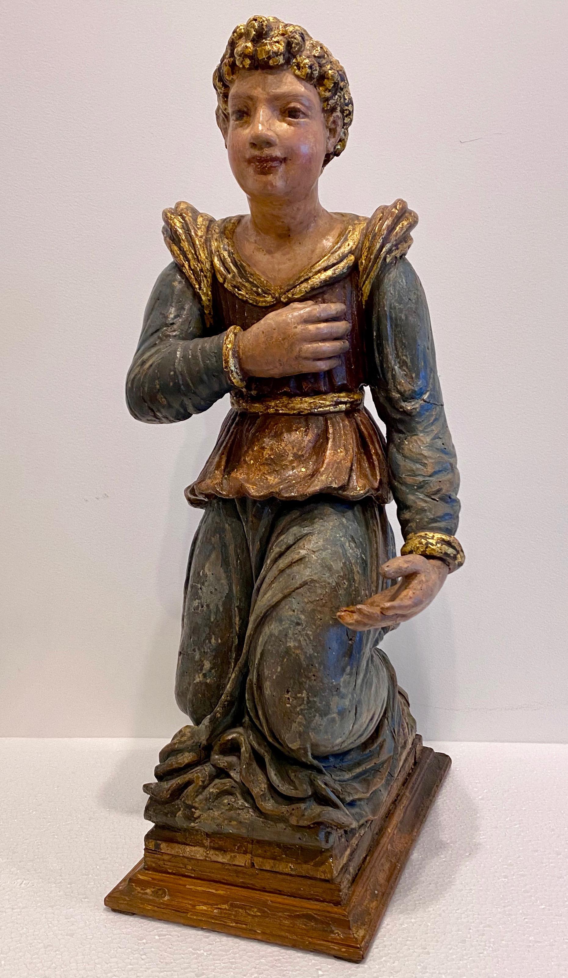 Italian Baroque painted and lacquered wooden sculpture of a kneeling figure. Circa 1650.

 