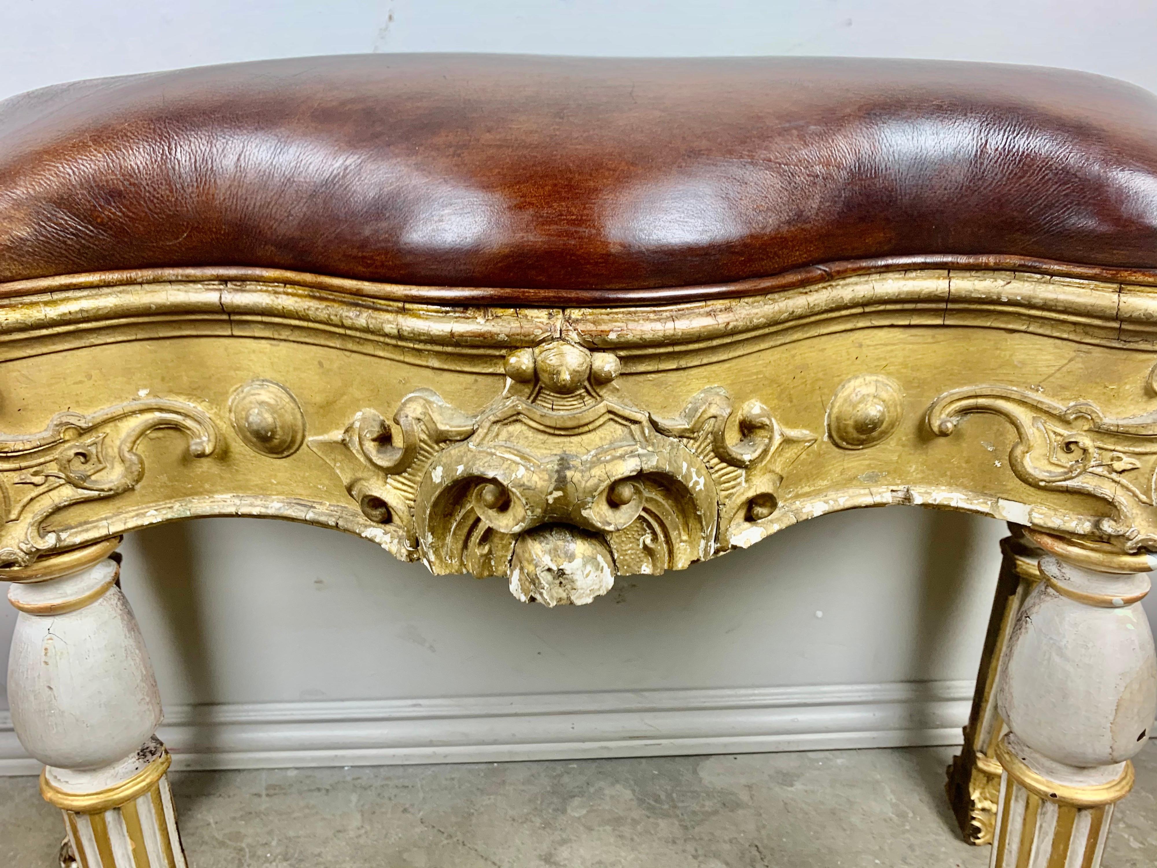 Italian Painted and Parcel Gilt Leather Bench In Distressed Condition For Sale In Los Angeles, CA