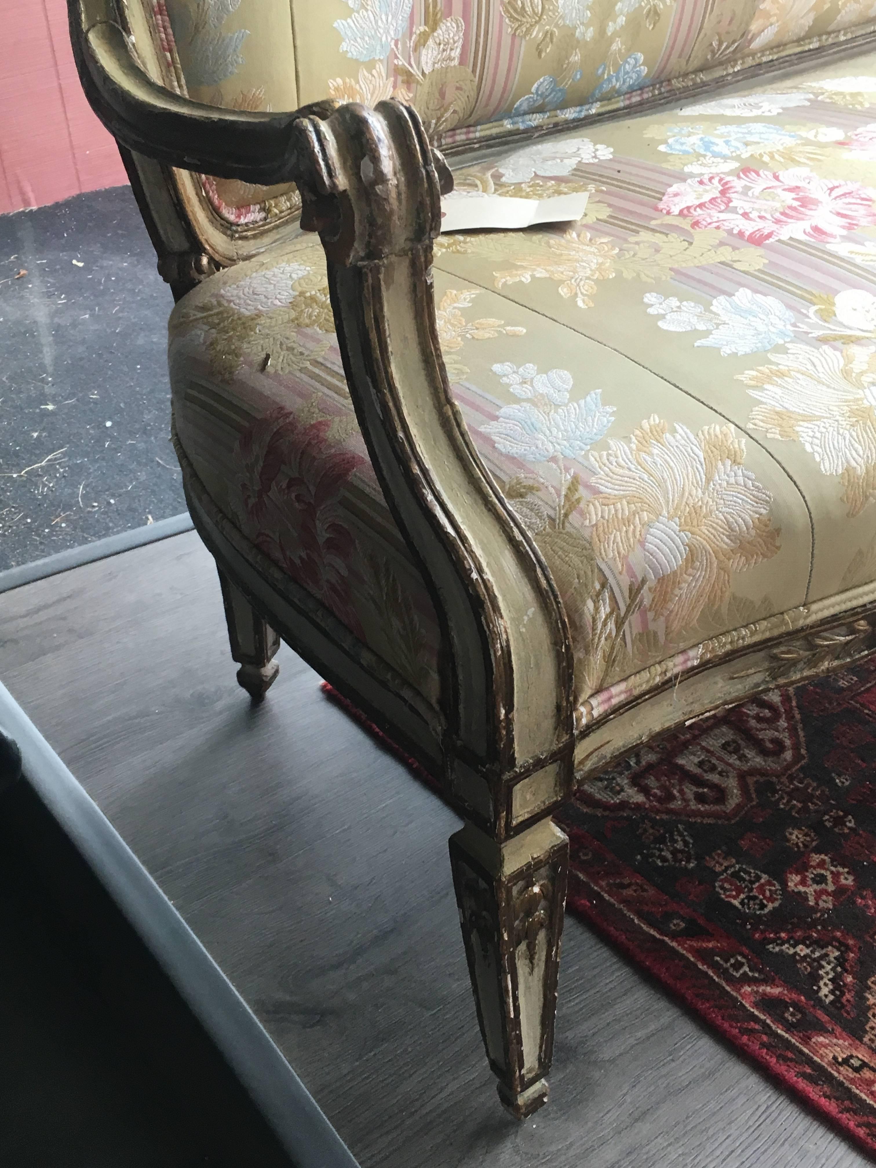 An Italian painted and parcel-gilt settee
18th century
having a pierce carved ribbon crest over a padded back and a stuff over seat, raised on square tapering legs.
Measure: Height 37 1/2 x width 69 x depth 23 inches.