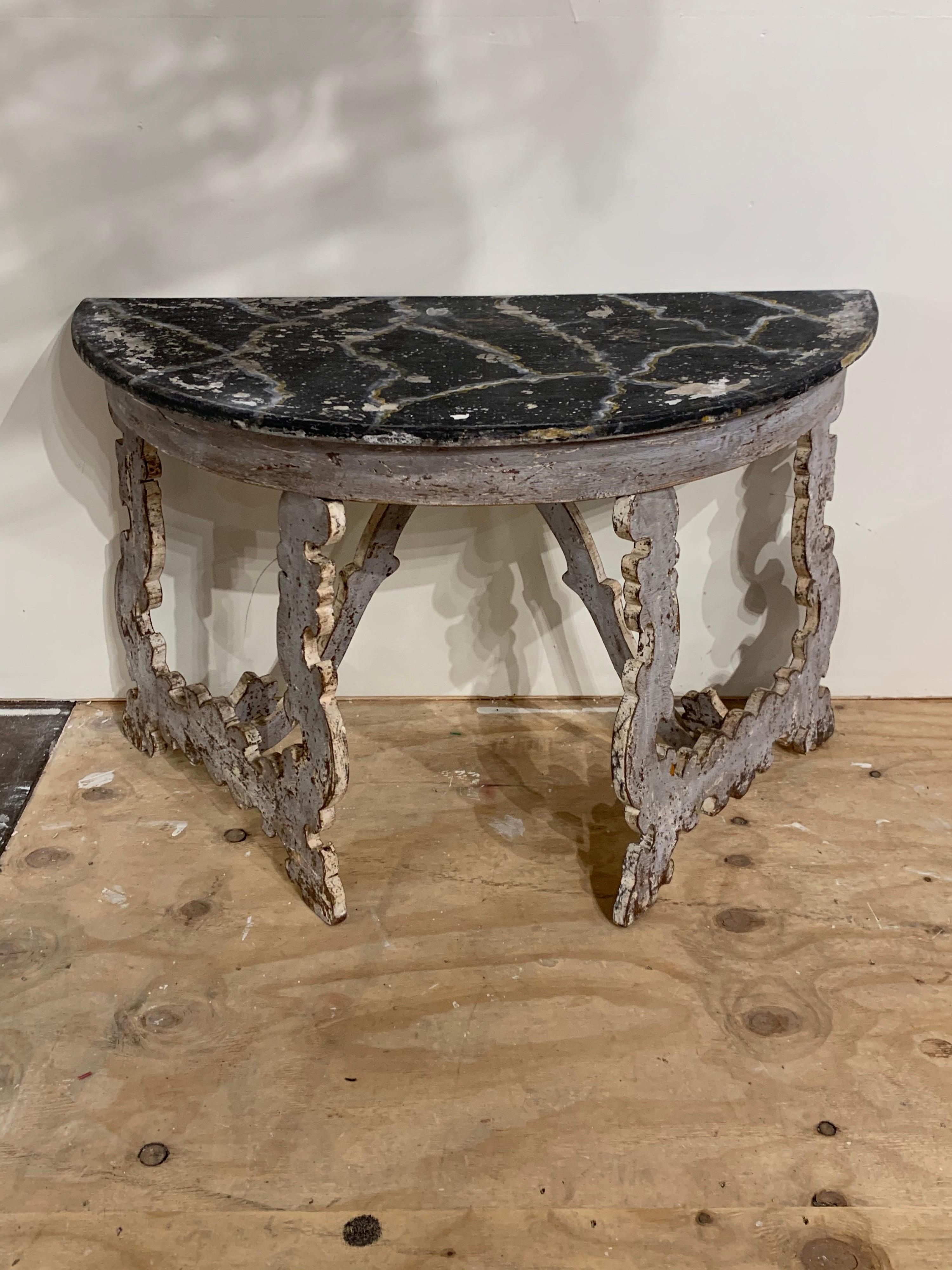 Interesting pair of Italian painted demilune consoles. Scrolling carved shape on the legs and decorative painted pattern on the tops. Makes a stylish statement! Note: Price listed is for one.